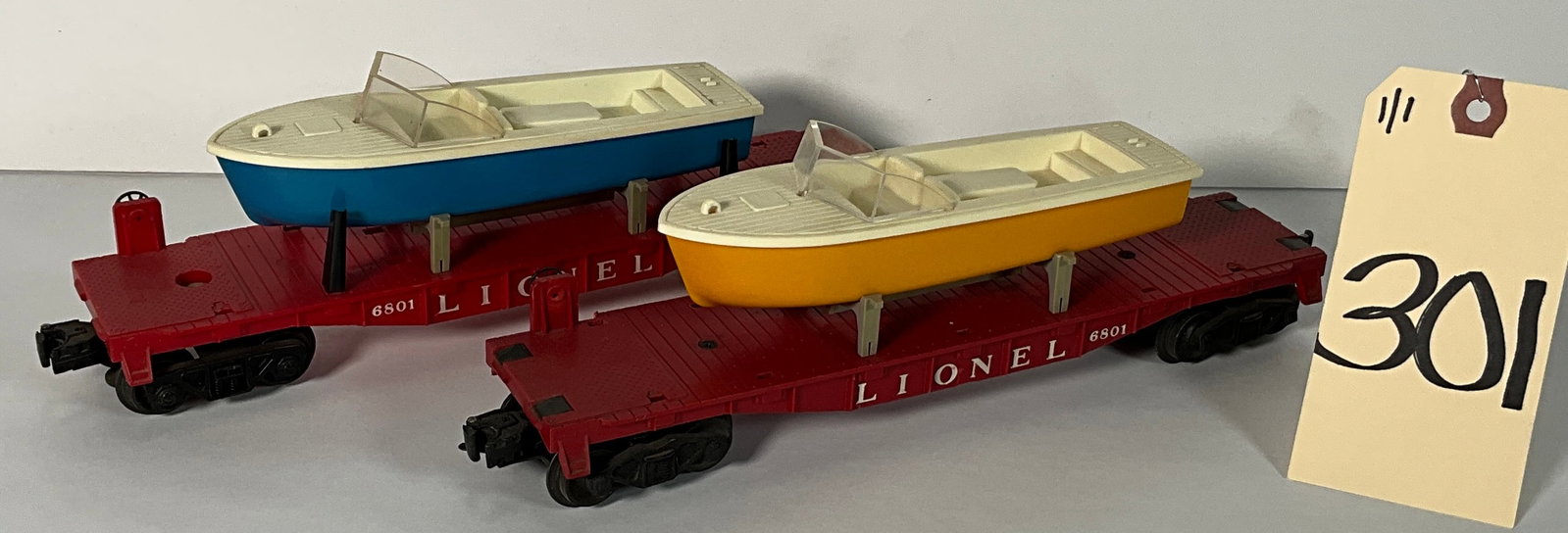 2 PC LIONEL 6801 BOAT TRANSPORT FLAT CARS.: 2 PC LIONEL 6801 BOAT TRANSPORT FLAT CARS. Condition All property is sold in "as is" condition and all sales are final. Teel Auctions and its consignor make no representations or warranties, express o