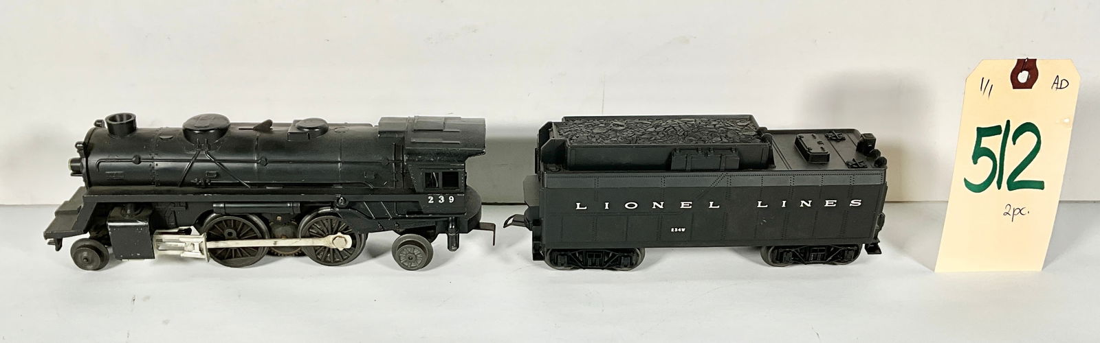 LIONEL 239 2-4-2 LOCOMOTIVE WITH 234W TENDER.: LIONEL 239 2-4-2 LOCOMOTIVE WITH 234W TENDER. Condition All property is sold in "as is" condition and all sales are final. Teel Auctions and its consignor make no representations or warranties, expres
