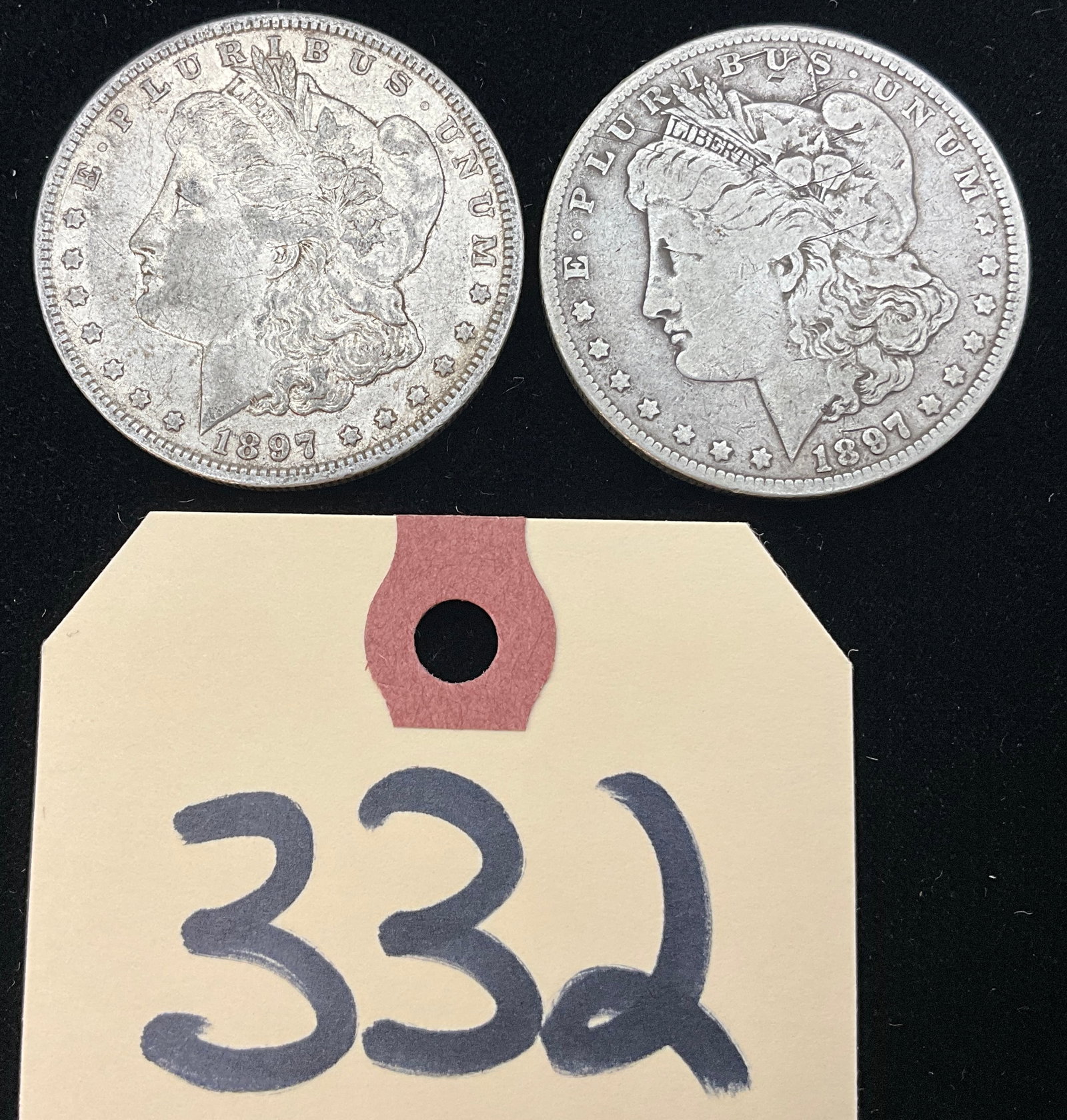 PAIR OF 1897-O MORGAN SILVER DOLLARS. (1 of 3)