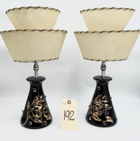 BLACK AND GOLD MID CENTURY CERAMIC TABLE LAMP WITH TIERED HIDE LAMPSHADES.