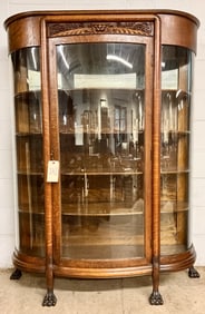 ANTIQUE LION CARVED BOW FRONT CHINA CABINET.