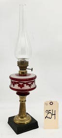 ANTIQUE RED PECKING GLASS OIL LAMP WITH BRASS BASE.