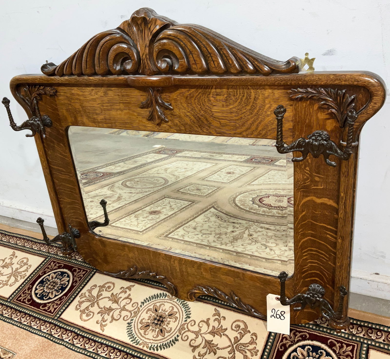ANTIQUE CARVED OAK BEVELED GLASS HALL MIRROR WITH BRASS HOOKS. (1 of 2)