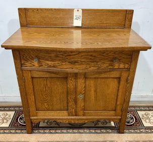 ANTIQUE OAK WASH STAND WITH BRASS PULLS.