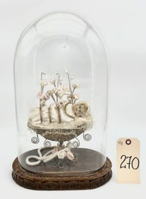 VICTORIAN WAX BABY IN CRADLE FIGURINE IN GLASS DOME WITH CARVED BASE.