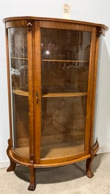 VINTAGE GRIFFIN CARVED OAK BOW FRONT CHINA CABINET.