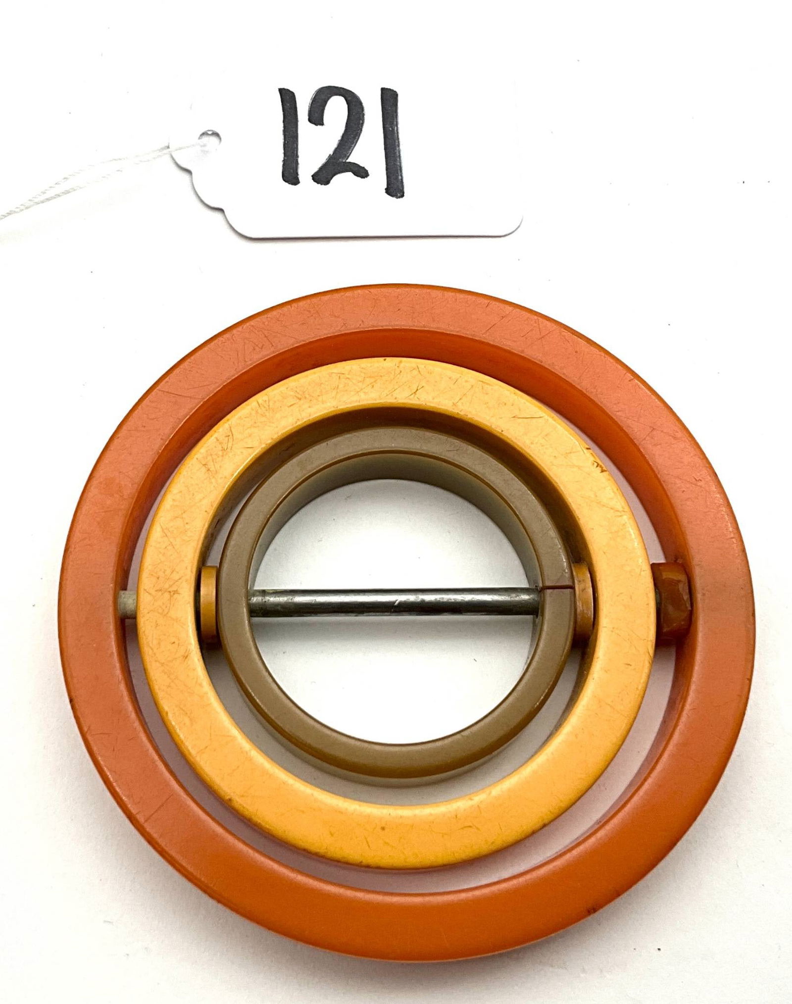 Bakelite Belt Buckle with 3-Inch Diameter: This is a Bakelite belt buckle, measuring 3 inches in diameter. Bakelite is a thermosetting plastic known for its early use in various applications, including accessories such as belt buckles. The buc