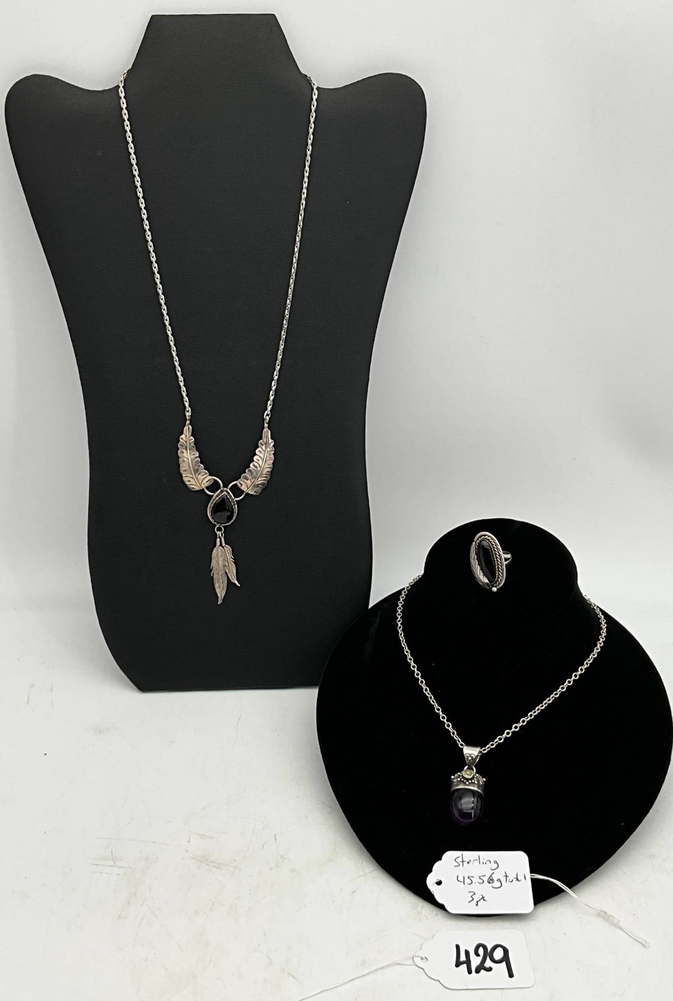 Sterling Silver Necklace and Ring Set Featuring Gemstone Accents: Sterling silver jewelry set including two 20-inch necklaces with pendant designs and a size 6.25 ring. The total weight of the lot is 45.56 grams. The necklaces feature feather-inspired accents and ge