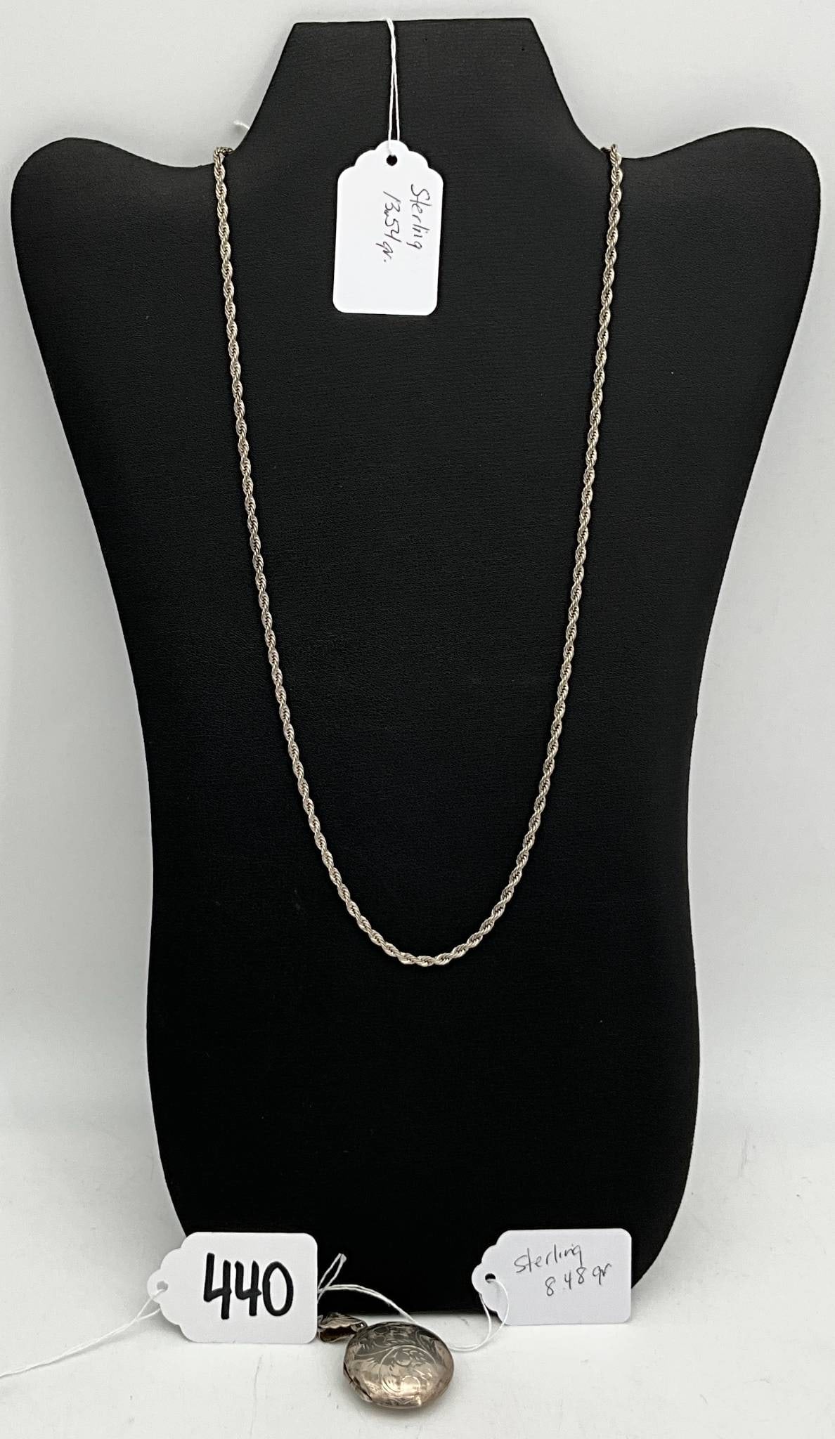 Sterling Silver 22-Inch Chain with Locket, 22.02 Grams: Sterling silver chain measuring 22 inches in length, with a total weight of 22.02 grams. Includes a round, engraved locket with intricate detailing and space for holding photos or small keepsakes. The