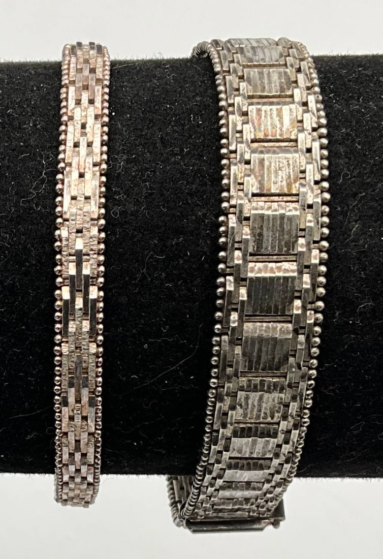 Sterling Silver Bracelets, 7 Inches Long: Sterling silver bracelets featuring intricate link designs. Both bracelets measure 7 inches long and have a combined total weight of 39.36 grams. The craftsmanship showcases detailed metalwork, making