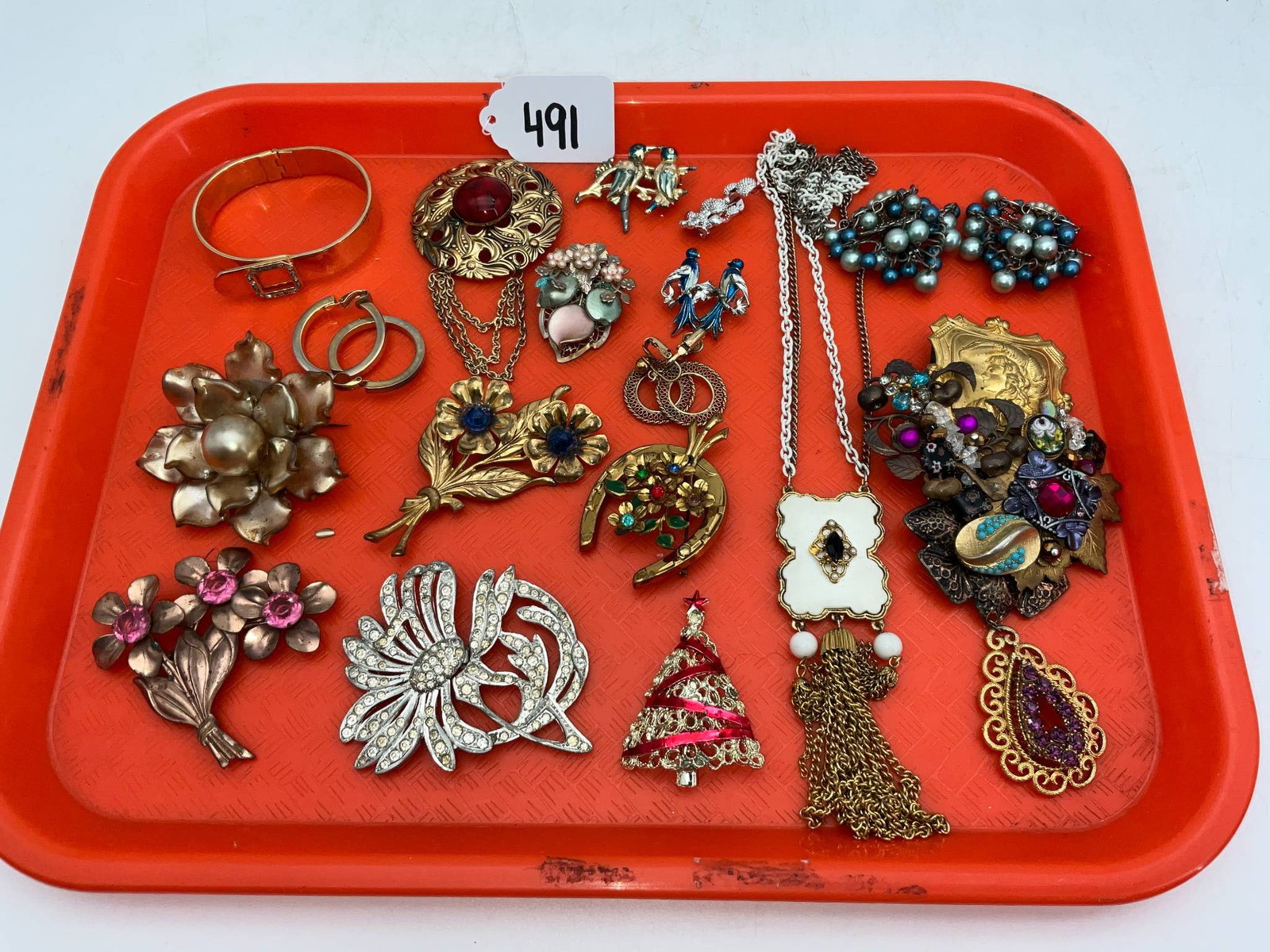 Costume Jewelry, Including Sarah Jane and Weiss: Costume jewelry featuring pieces from Sarah Jane, Weiss, and others. Includes necklaces, brooches, and clip-on earrings in gold-tone, silver-tone, and enamel finishes. Designs include floral motifs, h
