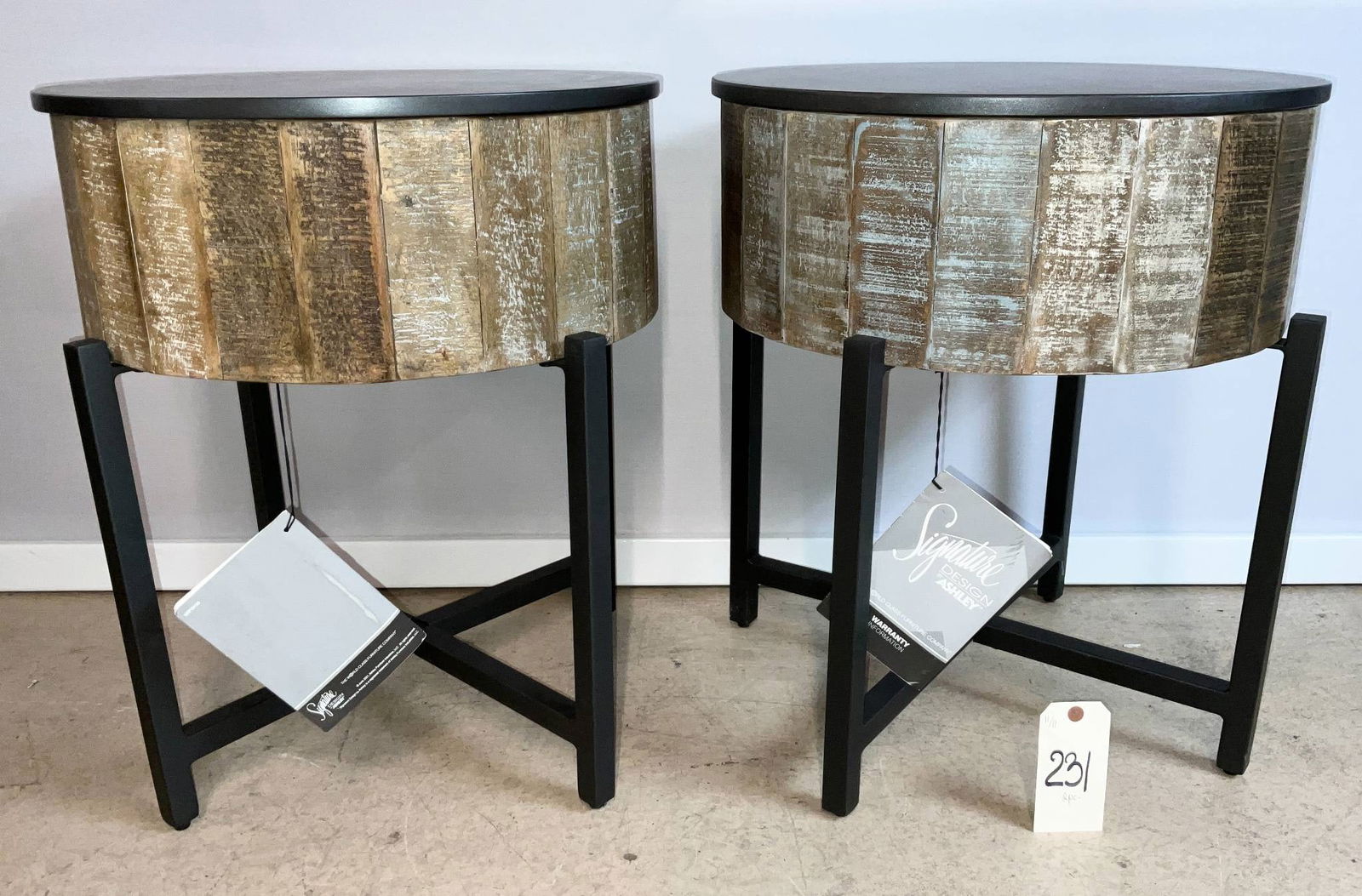 Ashley Signature Design Tables with Storage, 21-Inch Diameter, 24-Inch Height: Ashley Signature Design storage tables featuring a 21-inch diameter and 24-inch height. Each table has a removable round black top that reveals interior storage. The exterior features a textured metal