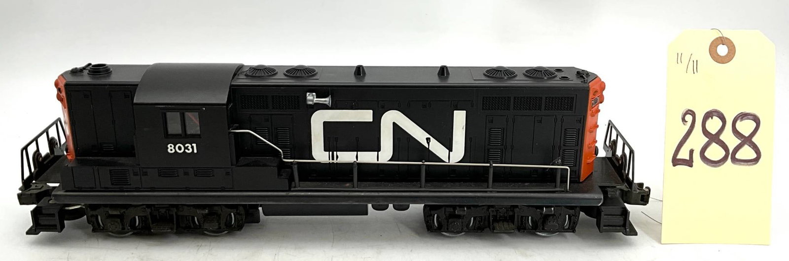 Lionel 8031 CN Diesel Engine, 14 Inches Long: Lionel 8031 Canadian National (CN) diesel engine model with black and orange finish and CN logo prominently displayed on both sides. Measures 14 inches in length. Features distinctive detailing, inclu