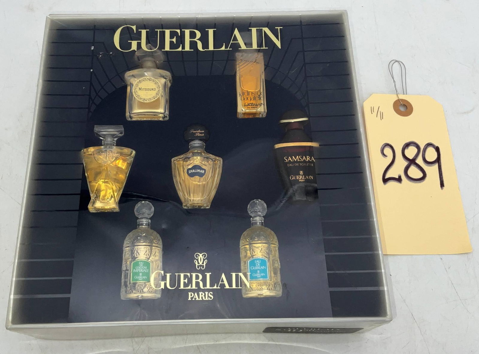 Guerlain Miniature Fragrance Collection Set with Display Box: Guerlain miniature fragrance collection set featuring six iconic perfume bottles, each showcasing a different scent, including Shalimar, Mitsouko, L'Heure Bleue, Chamade, Samsara, and a labeled Eau de