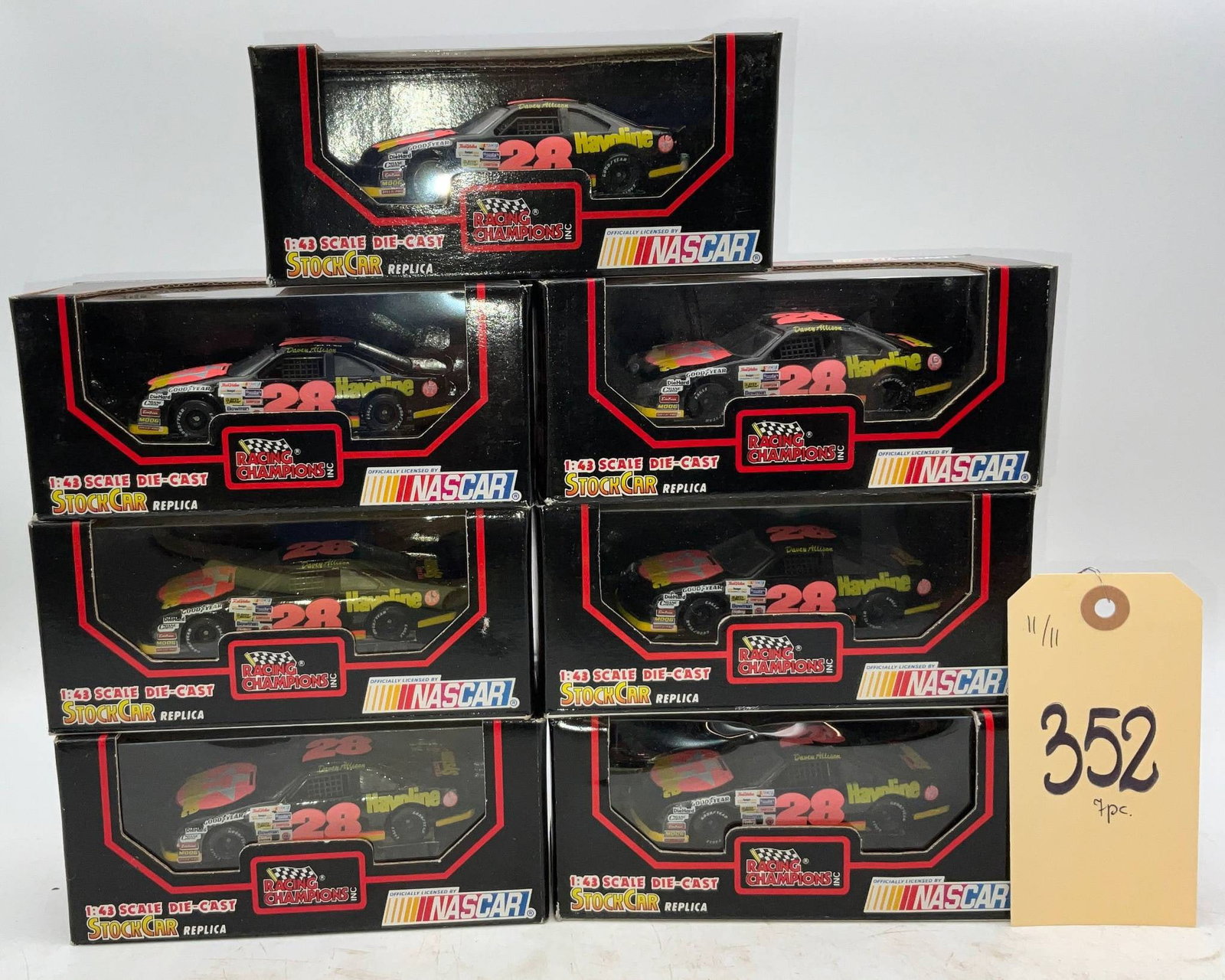7 NASCAR 1:24 Scale Die-Cast Cars in Original Packaging: Seven NASCAR 1:24 scale die-cast cars, each in its original printed packaging. The boxes feature branding and details pertaining to NASCAR, including specific car replicas. Suitable for collectors and