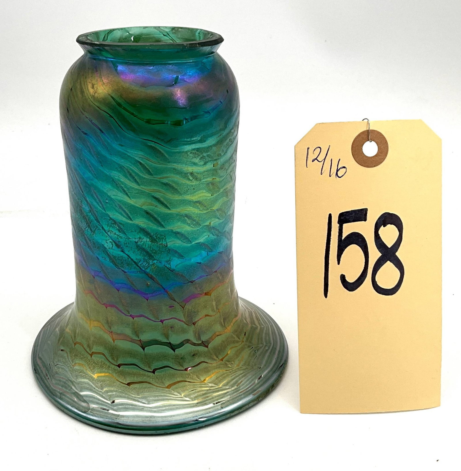 Vintage Iridescent Art Glass Shade, 4.75 Inches Wide and 6 Inches Tall: Vintage art glass shade featuring an iridescent finish with a wavy, pulled feather pattern in hues of green, gold, and purple. Constructed with blown glass, the shade measures 4.75 inches in diameter