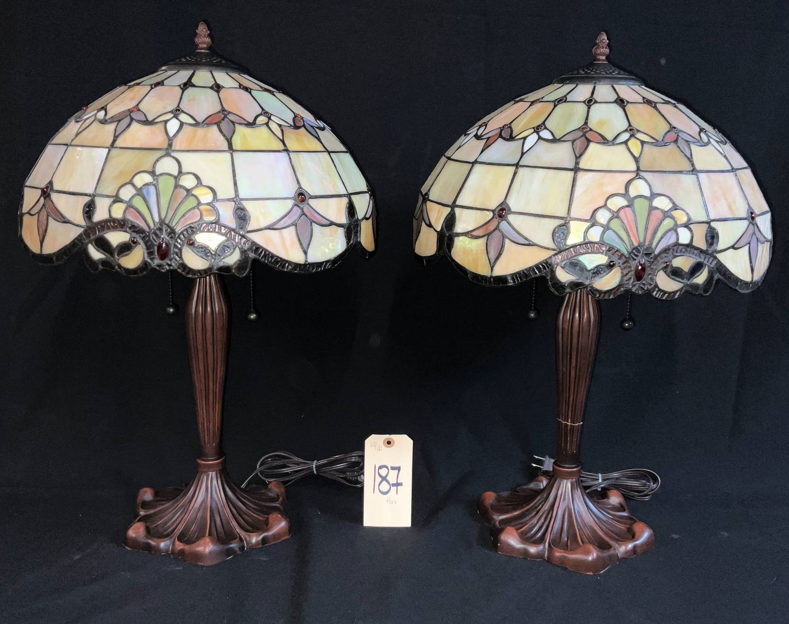 Stained Glass Table Lamps with Composite Bases, 24 Inches High: Table lamps featuring domed stained glass shades with floral and geometric motifs in muted tones. Shades include decorative elements with red accent pieces. Bases are constructed of composite material