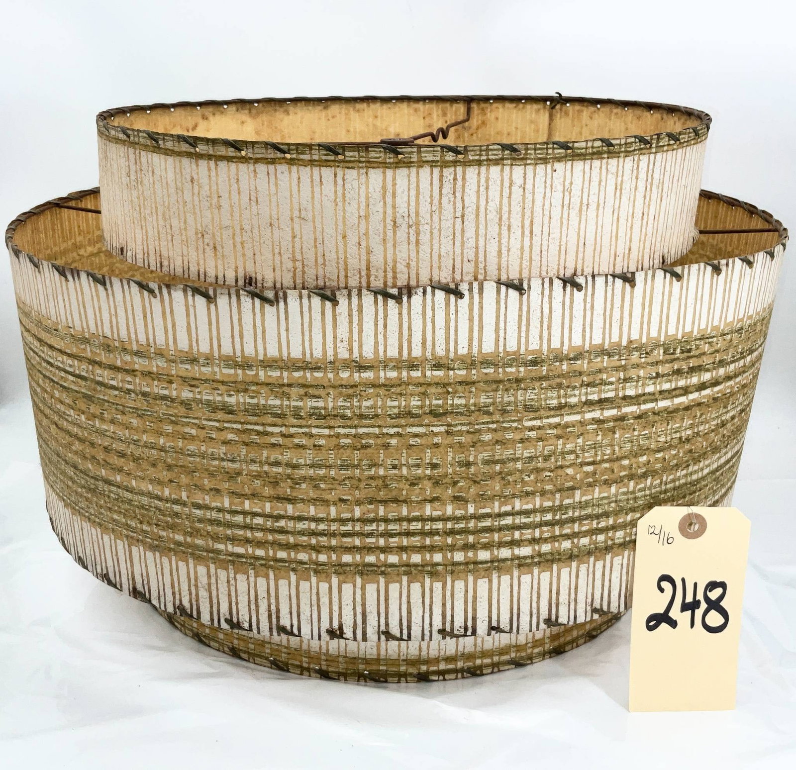 Mid-Century Modern Fiberglass and Woven String Drum Lampshade, 19 Inches Diameter: Mid-century modern drum-style lampshade featuring a dual-layer design with a woven string overlay on fiberglass. Measuring 19 inches in diameter and 12.5 inches high, the shade highlights clean, geome