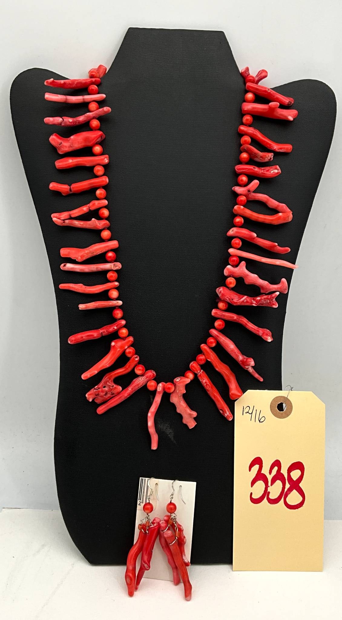Red Branch Coral Necklace and Earrings Set: Necklace and earrings set crafted from genuine red branch coral. The necklace features irregularly shaped coral branches strung with smooth round coral beads and is secured with a silver-tone clasp. T
