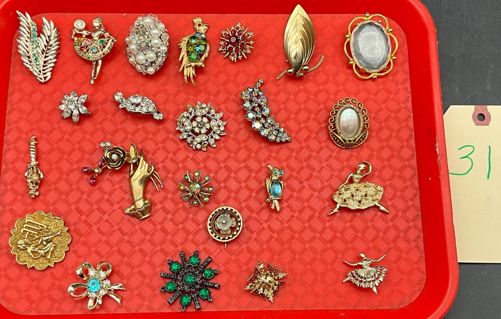 Hattie Carnegie, Coro, and Others Costume Jewelry Pins and Brooches: 20 pins and brooches, featuring designs attributed to Hattie Carnegie, Coro, and others. Includes gold-tone, silver-tone, and colorful rhinestone designs with figural and floral motifs. Pieces vary in