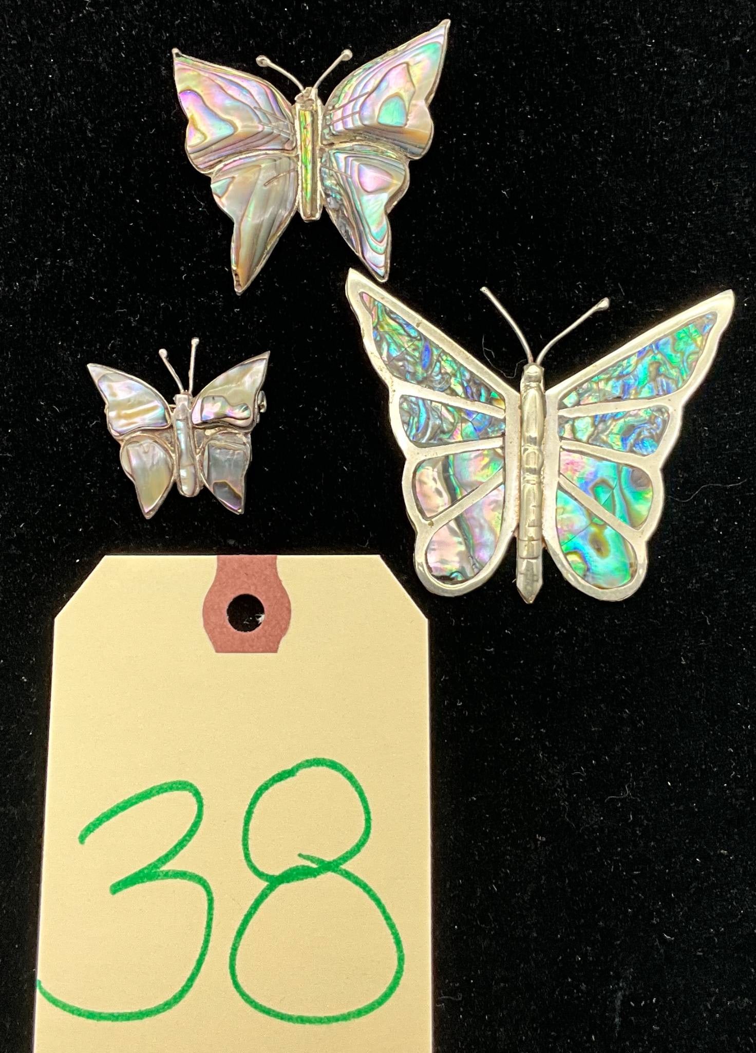 Three Sterling Silver Butterfly Pins with Abalone Inlay: Three sterling silver butterfly-form pins, featuring abalone shell inlays on wings. Total weight of the three pins is 24.06 grams. The designs vary in size, showcasing fine craftsmanship, and can serv