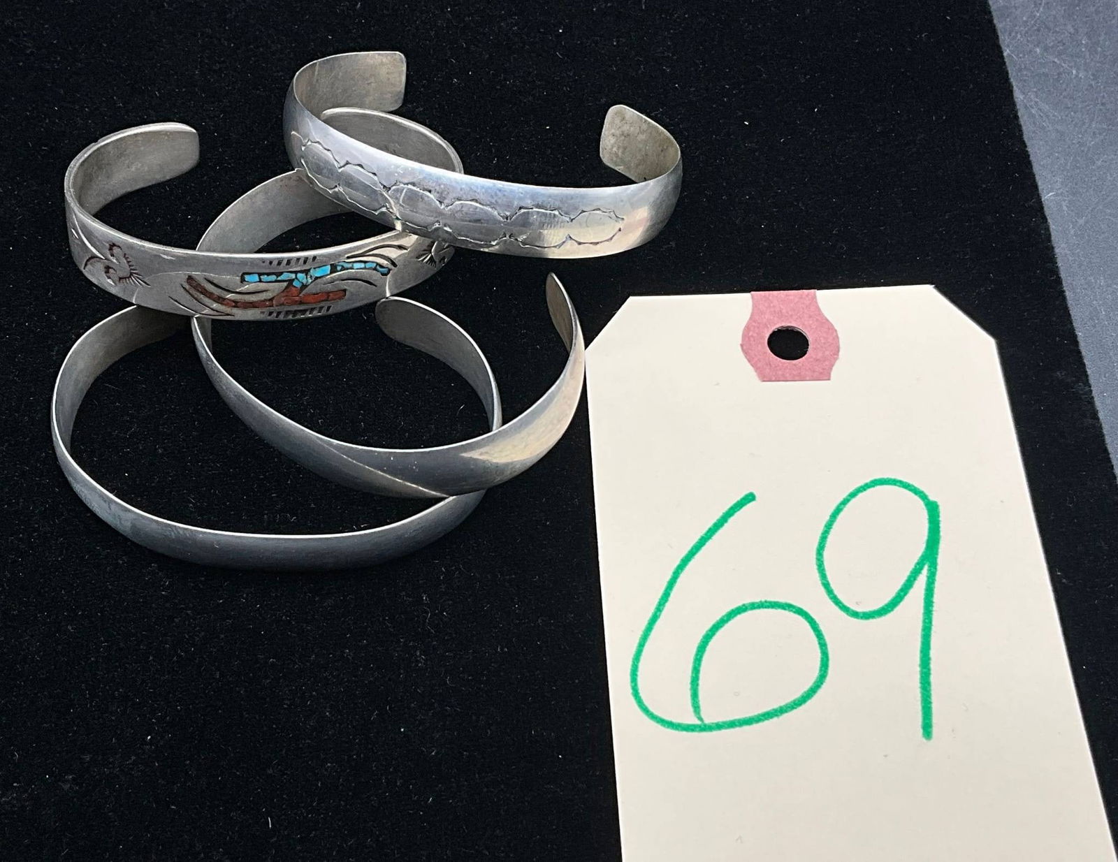 Four Sterling Silver Cuff Bracelets with Stamped and Inlaid Designs: Four solid sterling silver cuff bracelets, each approximately 2.5 inches in diameter and with a combined weight of 73.67 grams. Designs include a stamped leaf motif, a Thunderbird motif with turquoise
