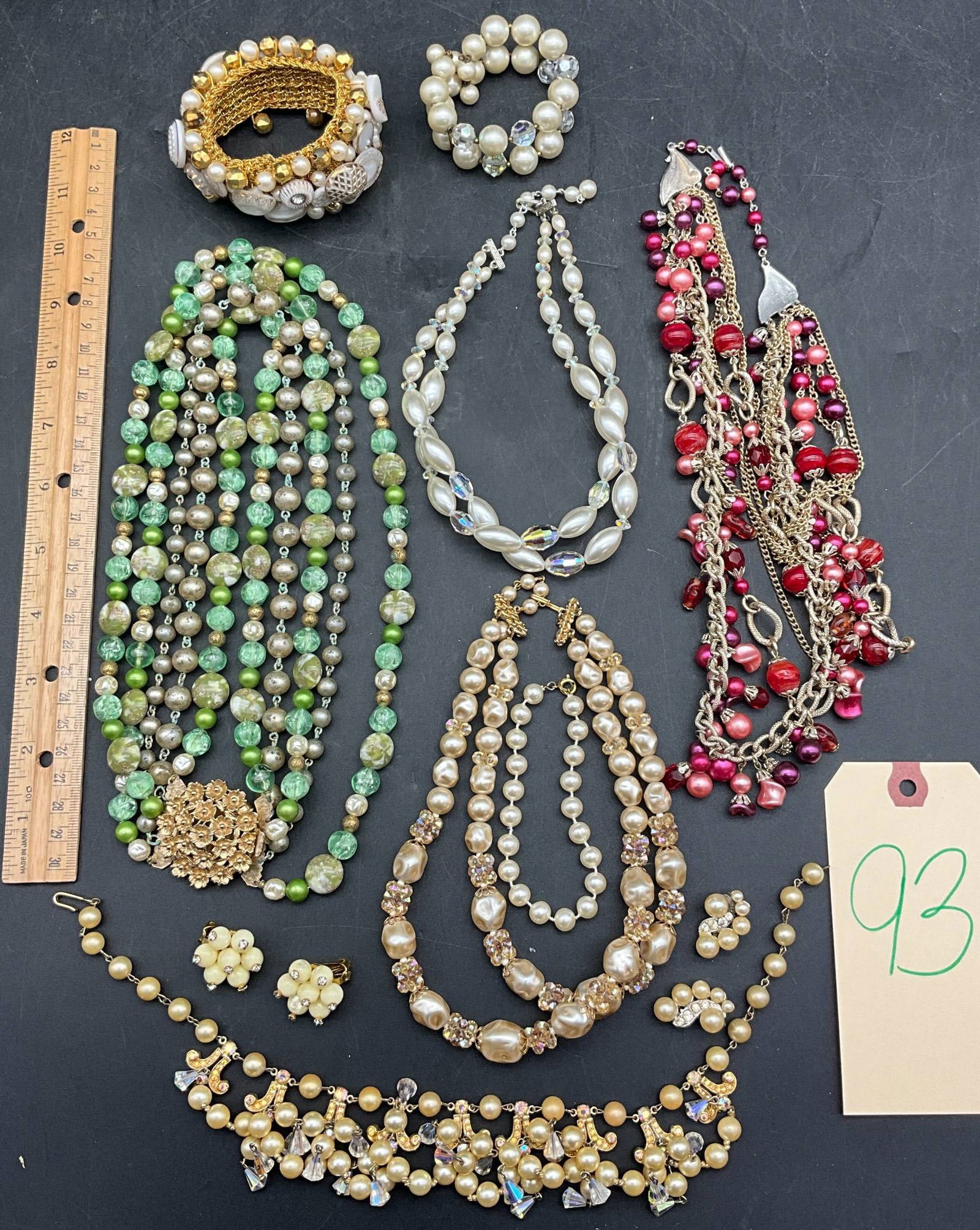 Faux Pearl and Bead Necklaces with Matching Jewelry, Unmarked: A diverse collection of faux pearl and bead necklaces, along with coordinating jewelry pieces. Features multi-strand necklaces with faux pearls and colored beads in shades of gold, green, and red. Mat