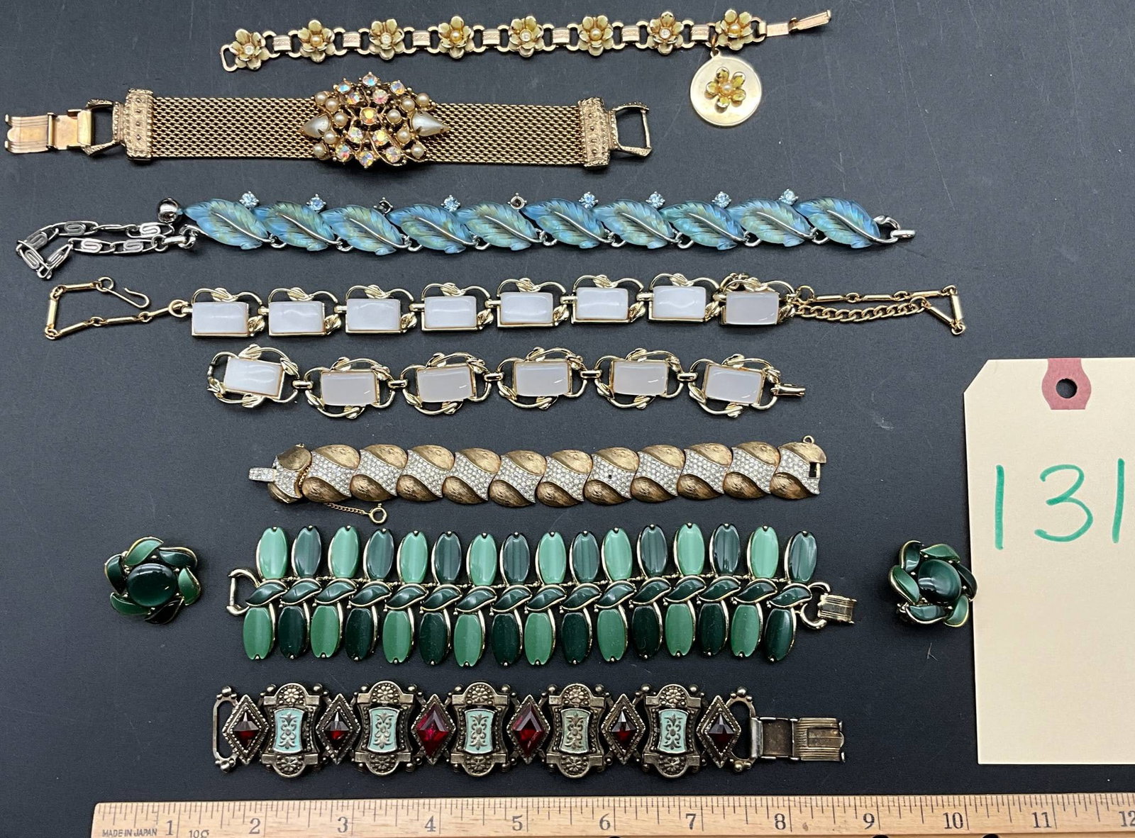 Vintage Lisner, Coro, Trifari, and Other Costume Jewelry Bracelets: Vintage costume jewelry bracelets by Lisner, Coro, Trifari, and others. Includes seven bracelets featuring various designs: floral motifs with enamel, faux gemstones, and metalwork, as well as leaf-in