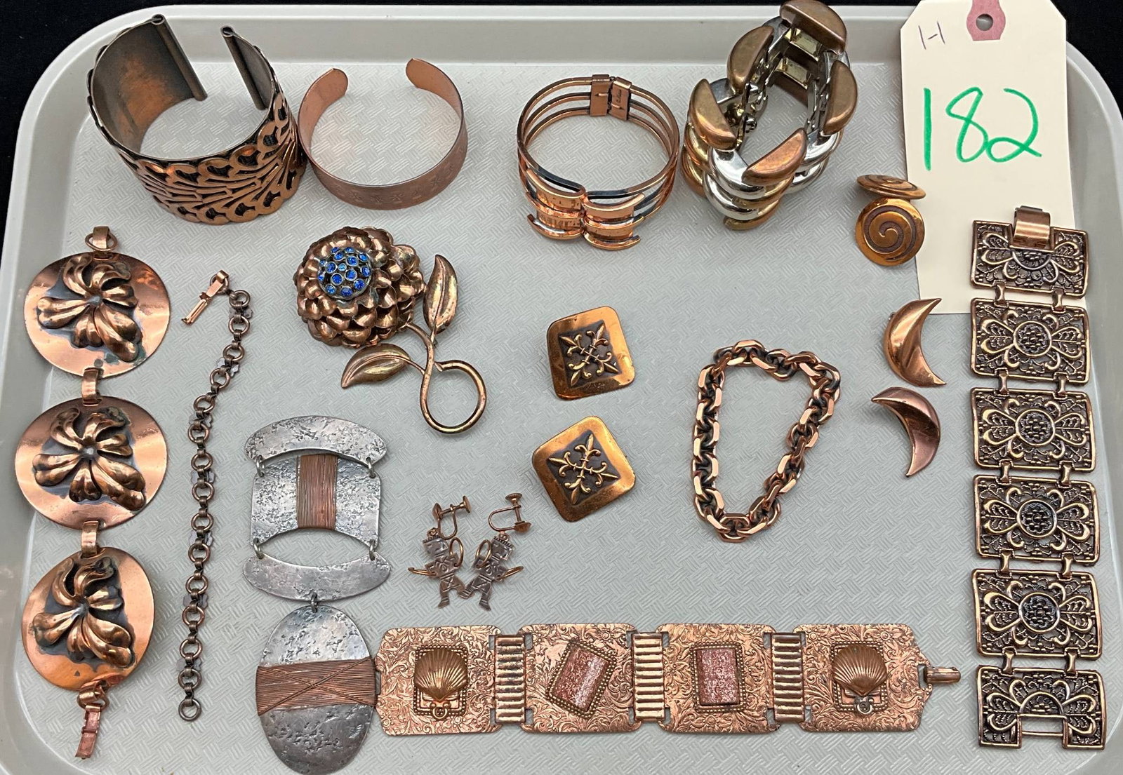 Copper and Metal Jewelry Assortment: Copper and metal jewelry pieces, including bracelets, necklaces, brooches, earrings, and cuffs. Several designs are designed by Renoir, Matisse, and other makers, known for their mid-20th century mode