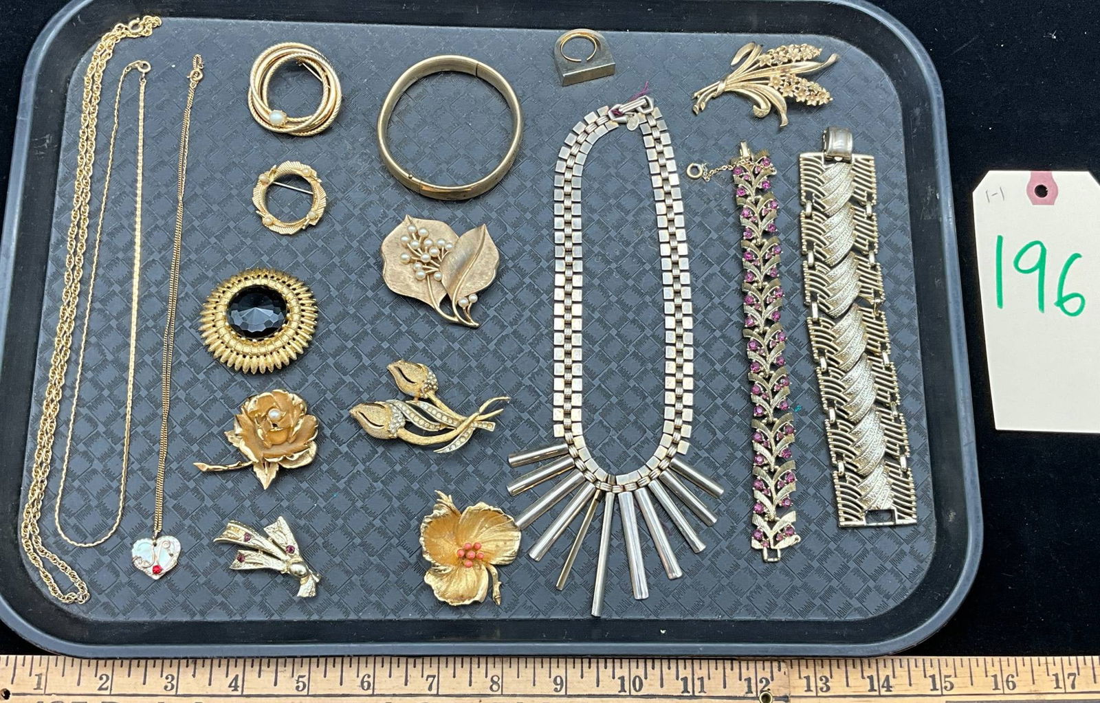 Vintage Gold-Toned Jewelry Collection Featuring Coro, Trifari, Park Lane, and Others: Vintage gold-toned jewelry, including necklaces, pins, bracelets, and a ring. Featured makers include Coro, Trifari, Park Lane, BSI, Boucher, and Lee Co. Many pieces showcase intricate designs, such a