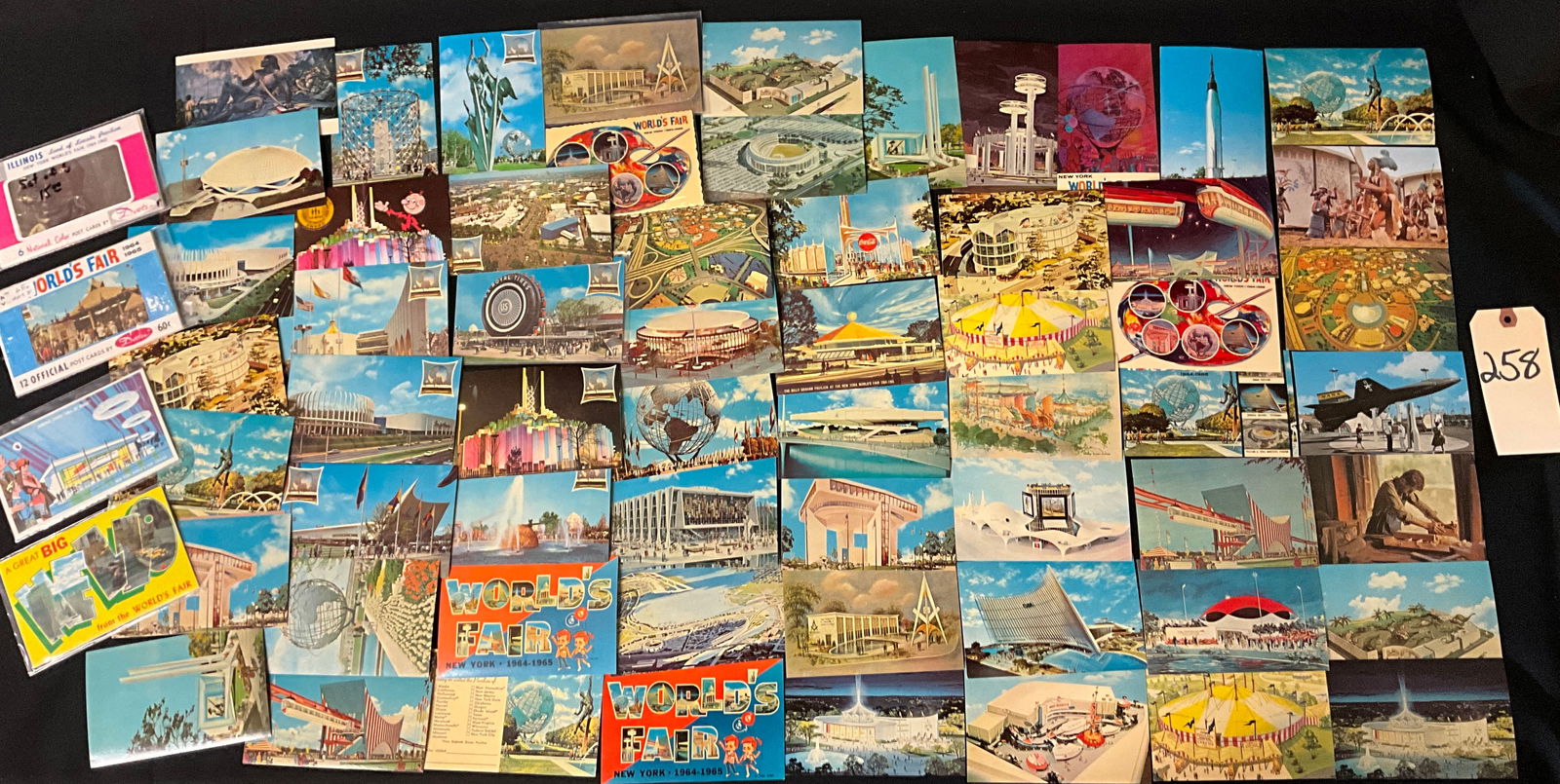 1964-1965 New York World's Fair Souvenir Postcard Collection: This collection features approximately 50 printed color postcards and two souvenir booklets from the 1964-1965 New York World's Fair, primarily published by Dexter Color New York, Inc. The cards