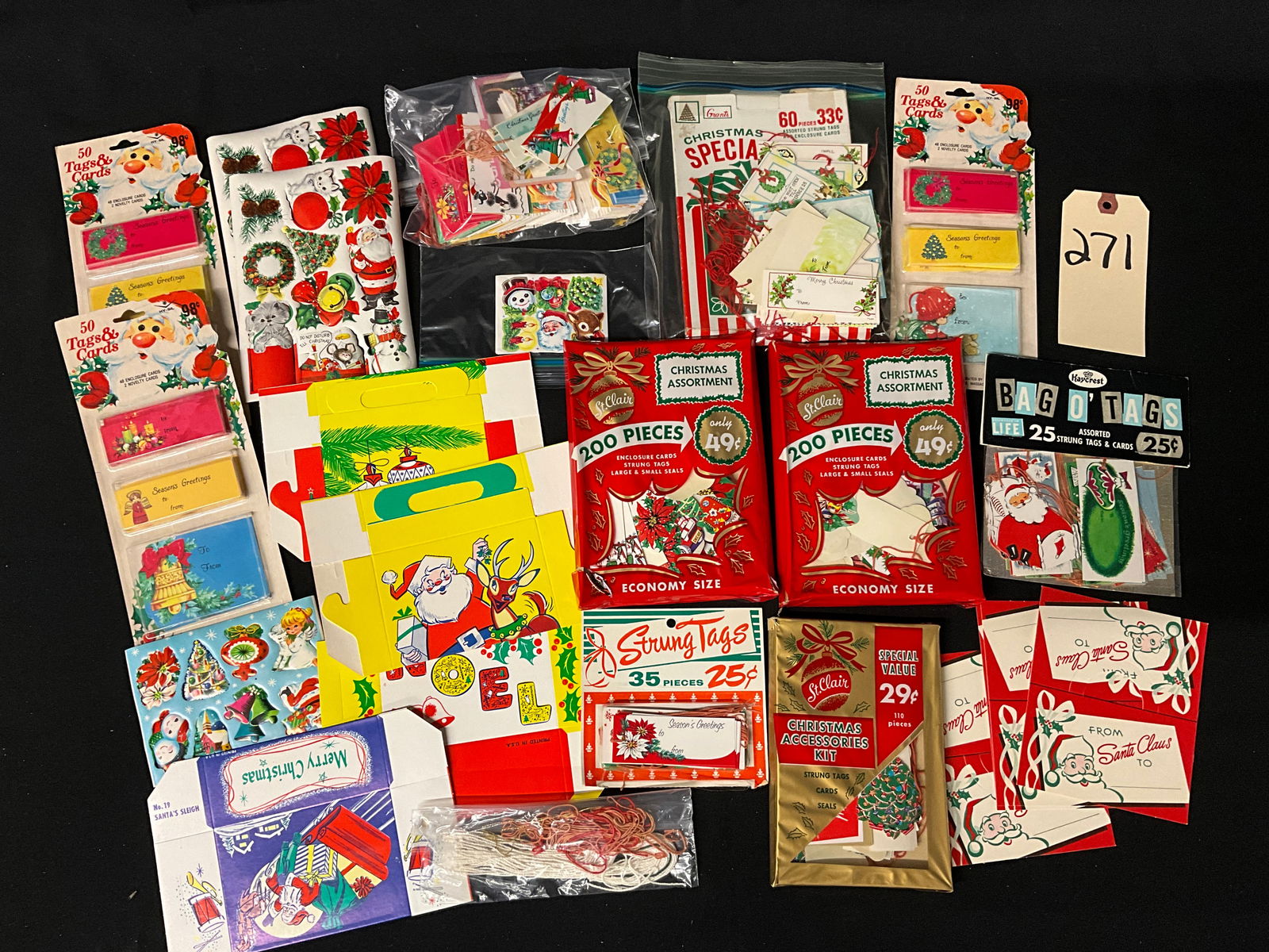 Vintage Christmas Ephemera, Stationery and Gift Accessories, Circa 1950s-1970s: This large assortment of mid-century holiday ephemera includes gift tags, enclosure cards, adhesive seals, and unassembled gift boxes. The collection features traditional motifs like Santa Claus and