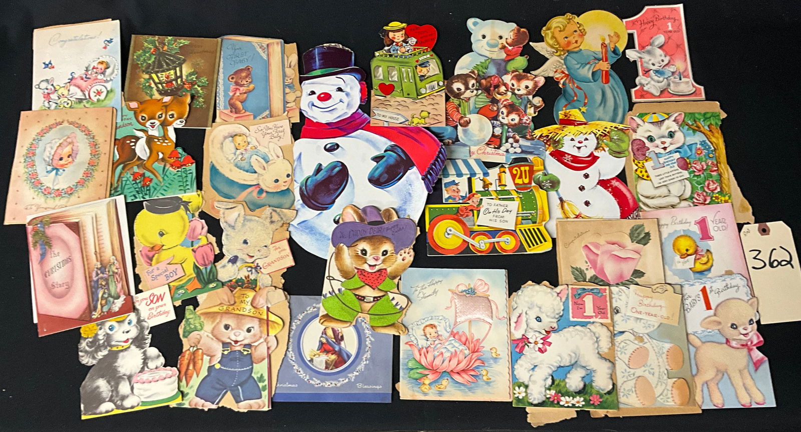 Mid-Century Holiday and Birthday Greeting Cards and Die-Cut Ephemera: This collection includes vintage paper ephemera, featuring large die-cut holiday figures like snowmen and angels alongside standard folding greeting cards. The subject matter captures mid-century