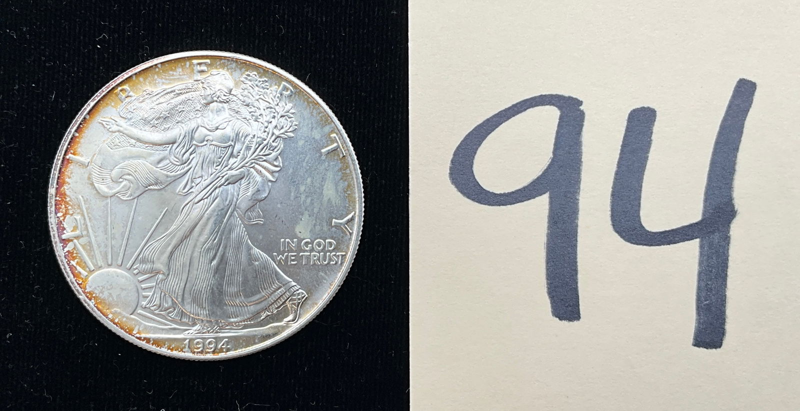 US 1994 One Dollar, Silver: KM-273. Designed by Adolph A. Weinman and John Mercanti. To describe the mint mark, none is present on this strike, indicating production at the Philadelphia Mint. This type of coin is an American