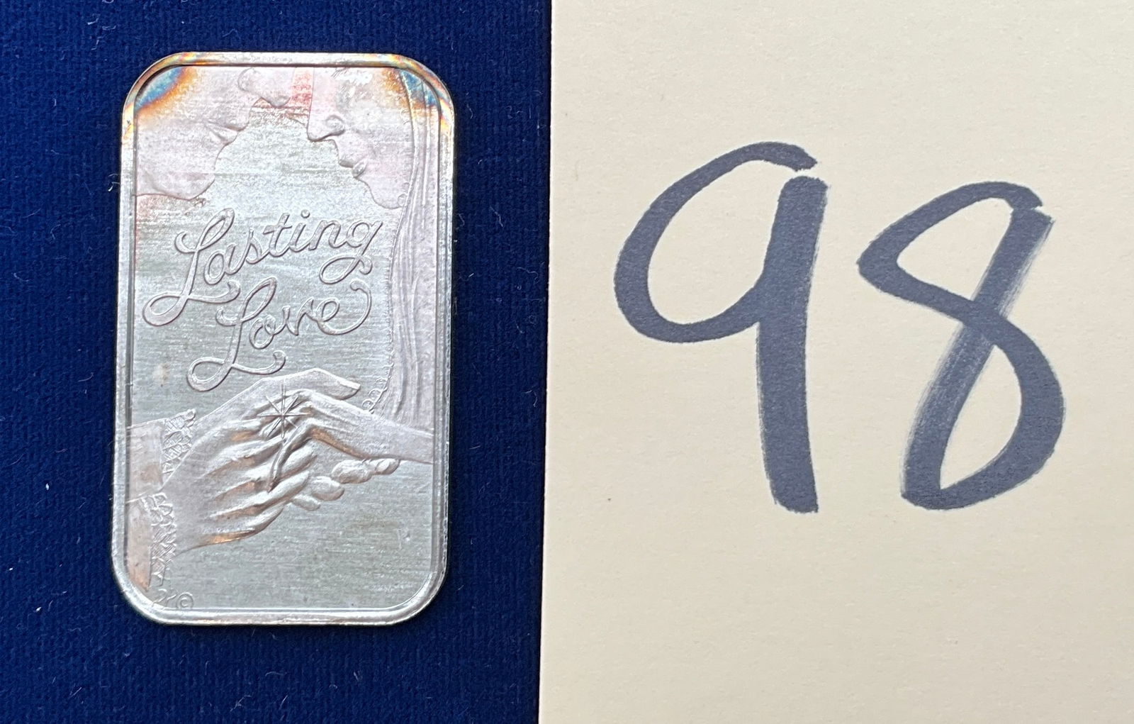 US Dahlonega Mint Lasting Love 1 oz Art Bar, Silver: Private issue by the Dahlonega Mint. This type of silver art bar features the Lasting Love obverse and a rectangular hallmark reverse. The mint mark DM is struck on the lower obverse. Regarding