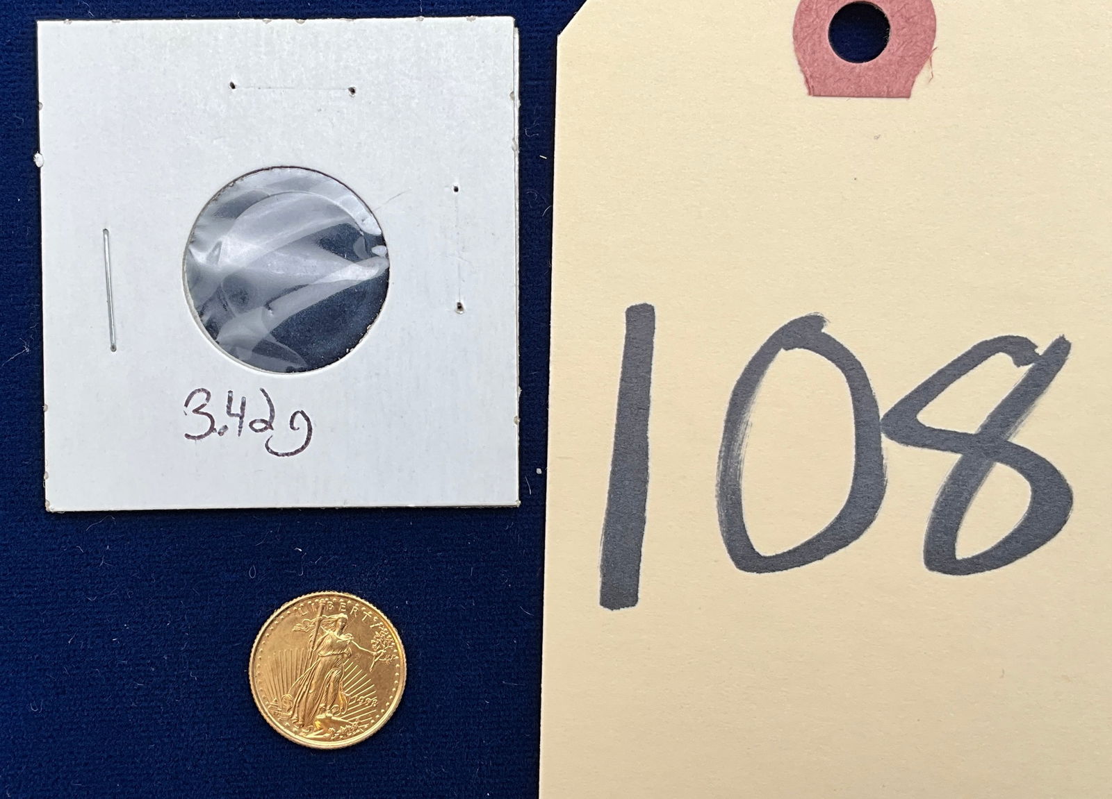 US 1998 $5 Gold, KM# 216: KM# 216. Designers: Augustus Saint-Gaudens and Miley Busiek. This specimen is a 1998 American Gold Eagle bullion coin. No mint mark is present. The coin is struck in gold with a purity of .9167 fine g