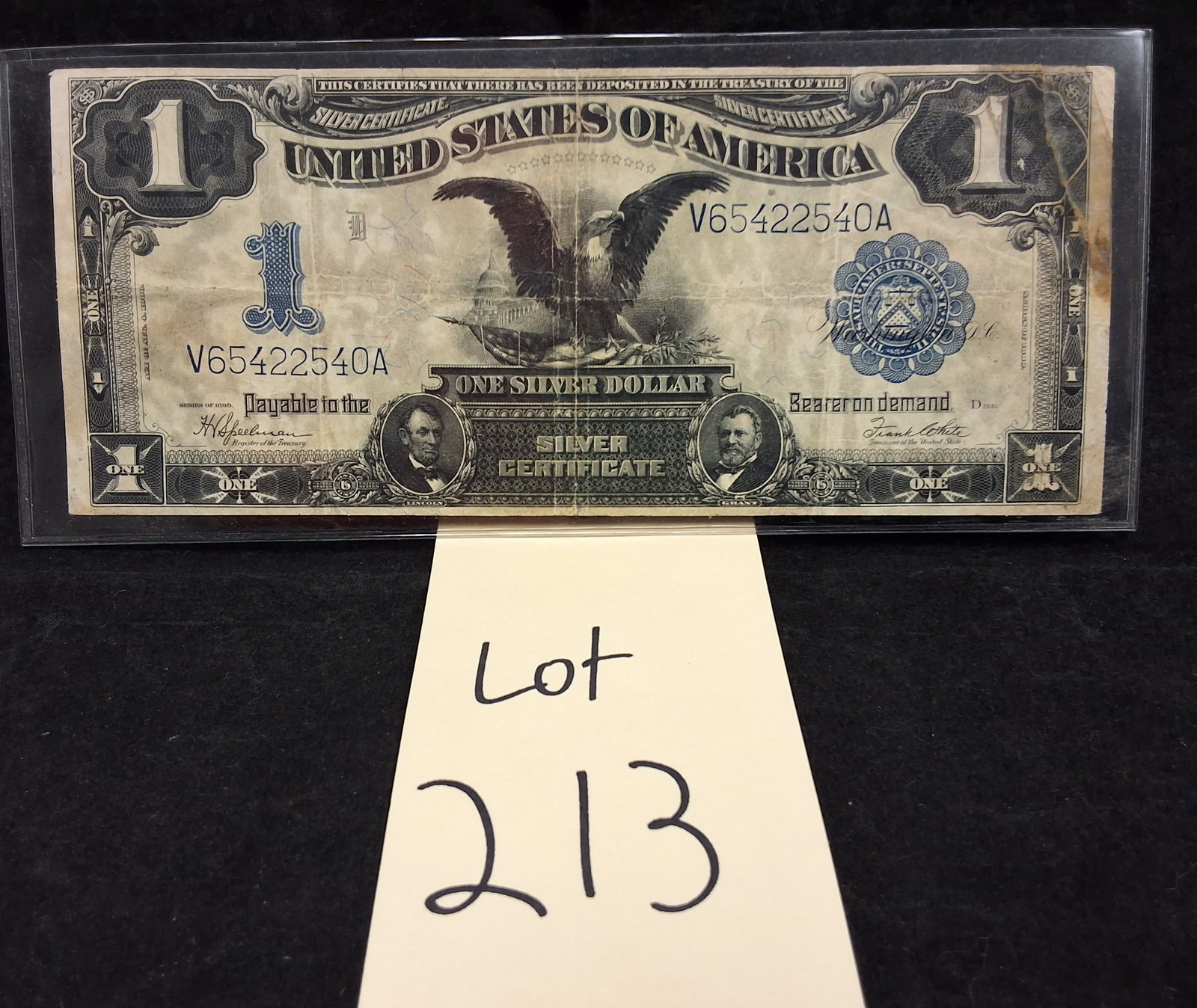 US 1899 $1 Silver Certificate, Fr. 236: Friedberg 236. Signatures of H.V. Speelman and Frank White. Black Eagle obverse type. Serial number V65422540A. Blue scalloped Treasury seal and blue serial numbers. This series represents the final l