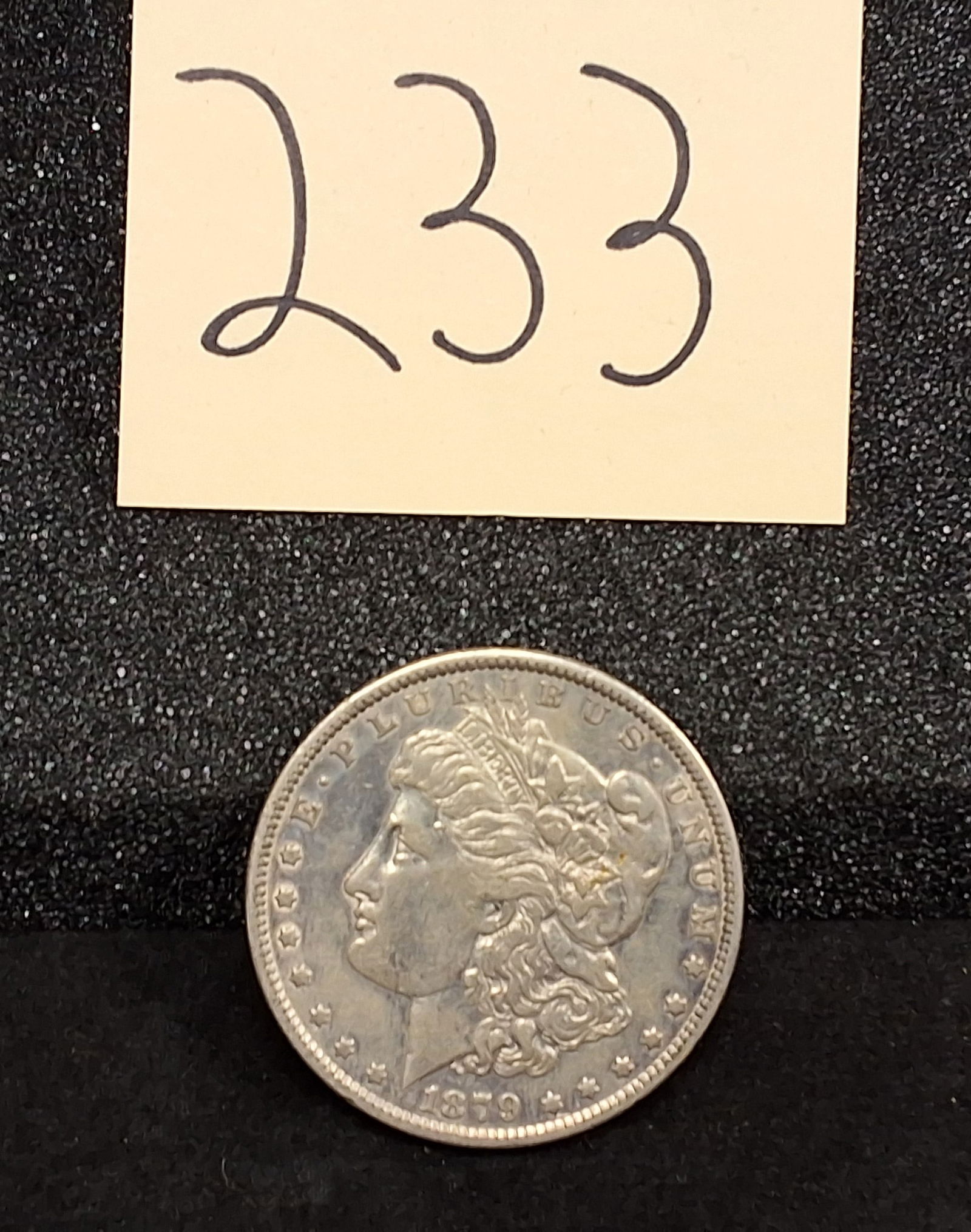 US 1879-P Morgan Dollar, Silver, KM-110: KM-110. Designer: George T. Morgan. Mint mark: None (Philadelphia). Liberty Head / Eagle. This 1879-P Morgan silver dollar was struck at the Philadelphia Mint. Condition All property is sold in "as is