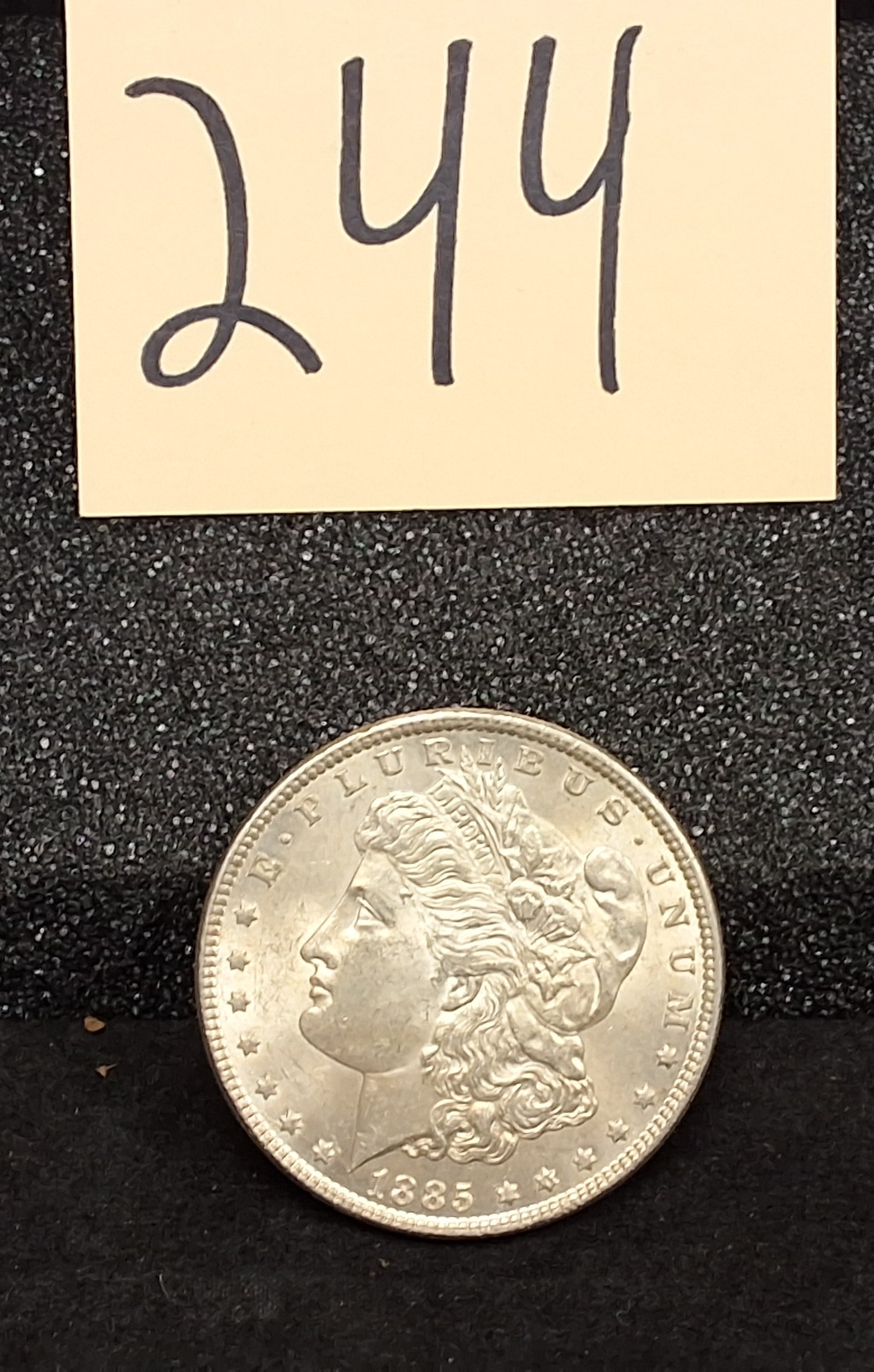 US 1885 One Dollar, Silver, KM-110: Catalog Number: KM-110. Designer: George T. Morgan. Mint: Philadelphia. Design Type: Morgan obverse / Eagle reverse. Mintage for this date and mint was 17,787,000. Condition All property is sold in "a