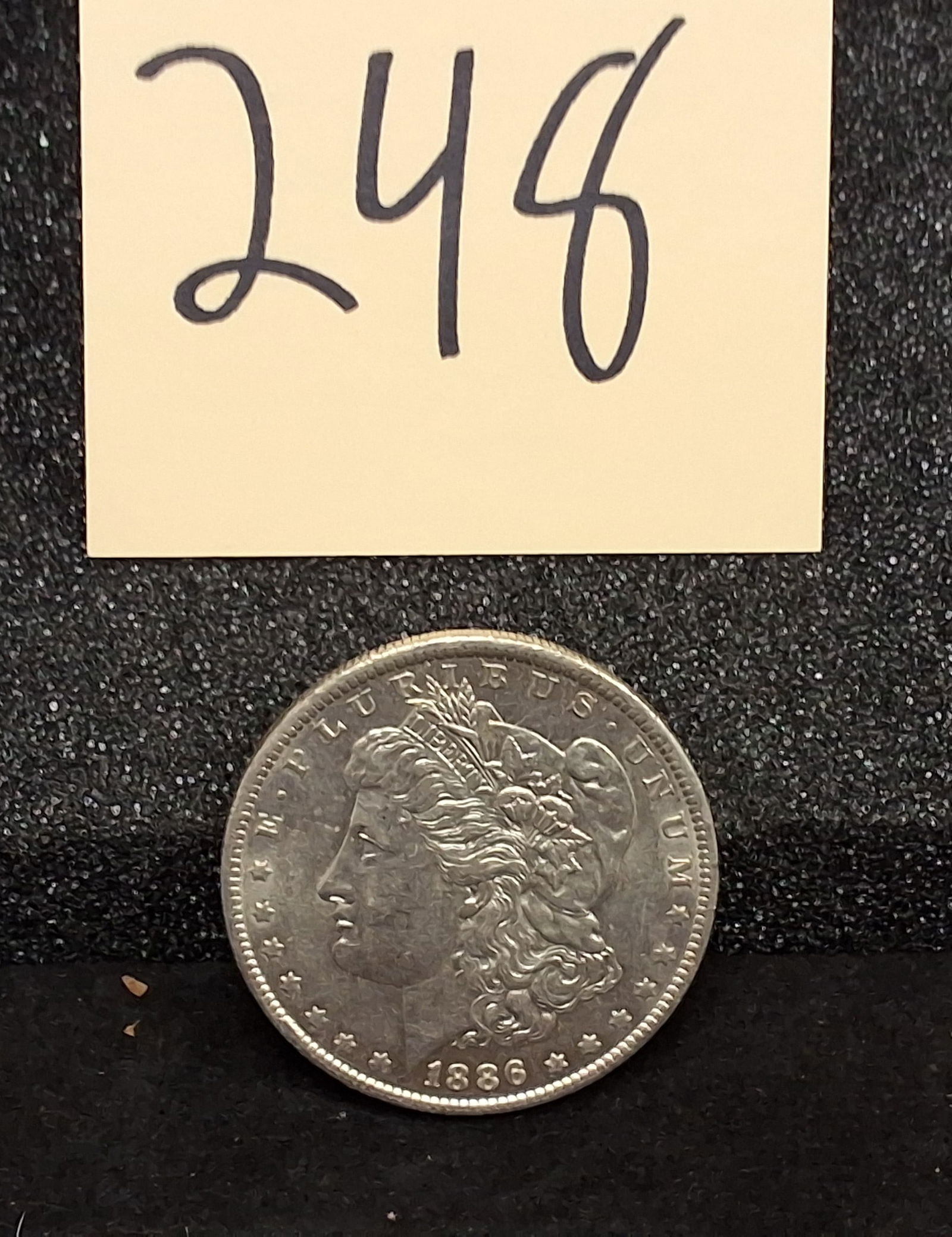US 1886-O Morgan Silver Dollar, Silver, KM-110: 1886-O Morgan silver dollar. Catalog: KM-110. Designer: George T. Morgan. New Orleans Mint. Morgan Liberty obverse / Eagle reverse. This issue had a mintage of 10,710,000 and is frequently encountered
