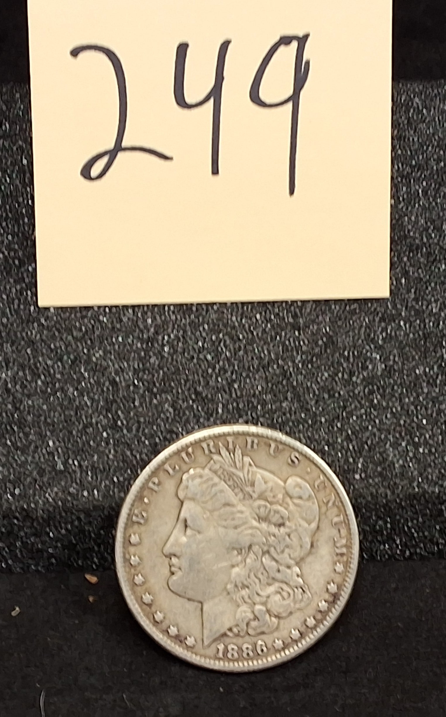 US 1886 Morgan Dollar, Silver, KM-110: KM-110. Designer: George T. Morgan. Philadelphia Mint. Morgan obverse / Eagle reverse. Mintage: 19,963,000. Condition All property is sold in "as is" condition and all sales are final. Teel Auctions a