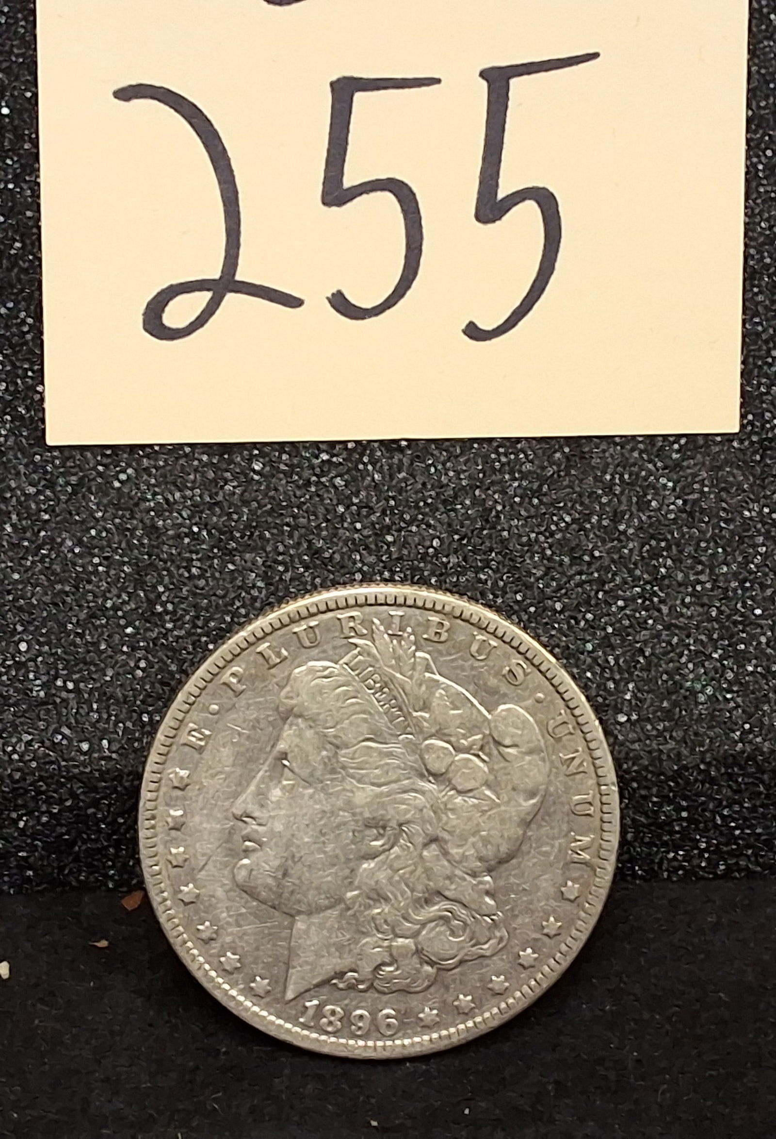 US 1896-O One Dollar, Silver, KM-110: KM-110. Designer: George T. Morgan. Mint mark O, New Orleans. Morgan obverse / Eagle reverse. The 1896-O is a common date in circulated grades but becomes significantly scarcer in Mint State. Conditio