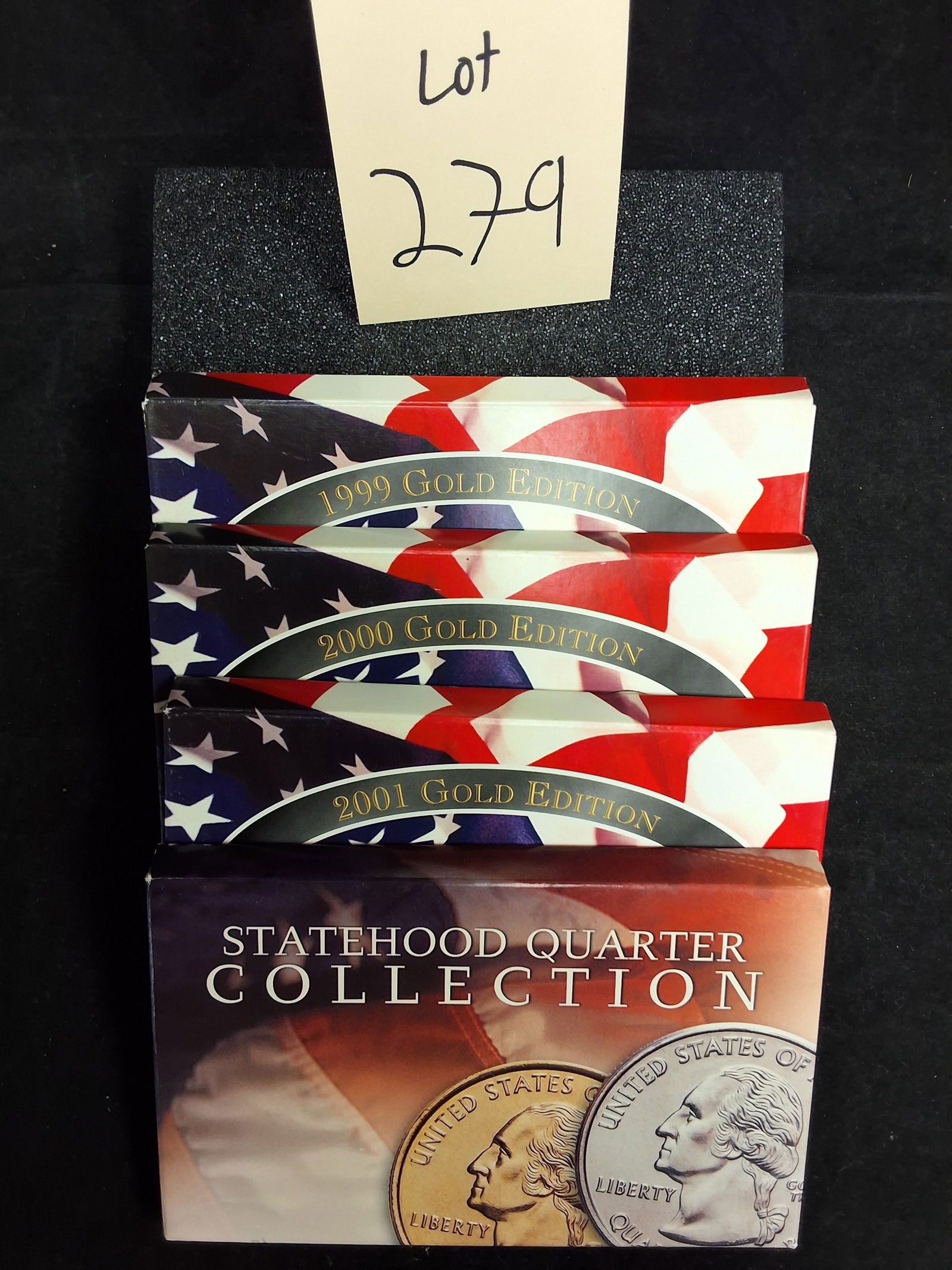 US 1999-2001 Statehood Quarter Gold Edition Sets, Gold-Plated: A group of United States Statehood Quarter Gold Edition sets featuring coins from 1999, 2000, and 2001. Each set contains five quarters with aftermarket 24-karat gold plating applied to the original
