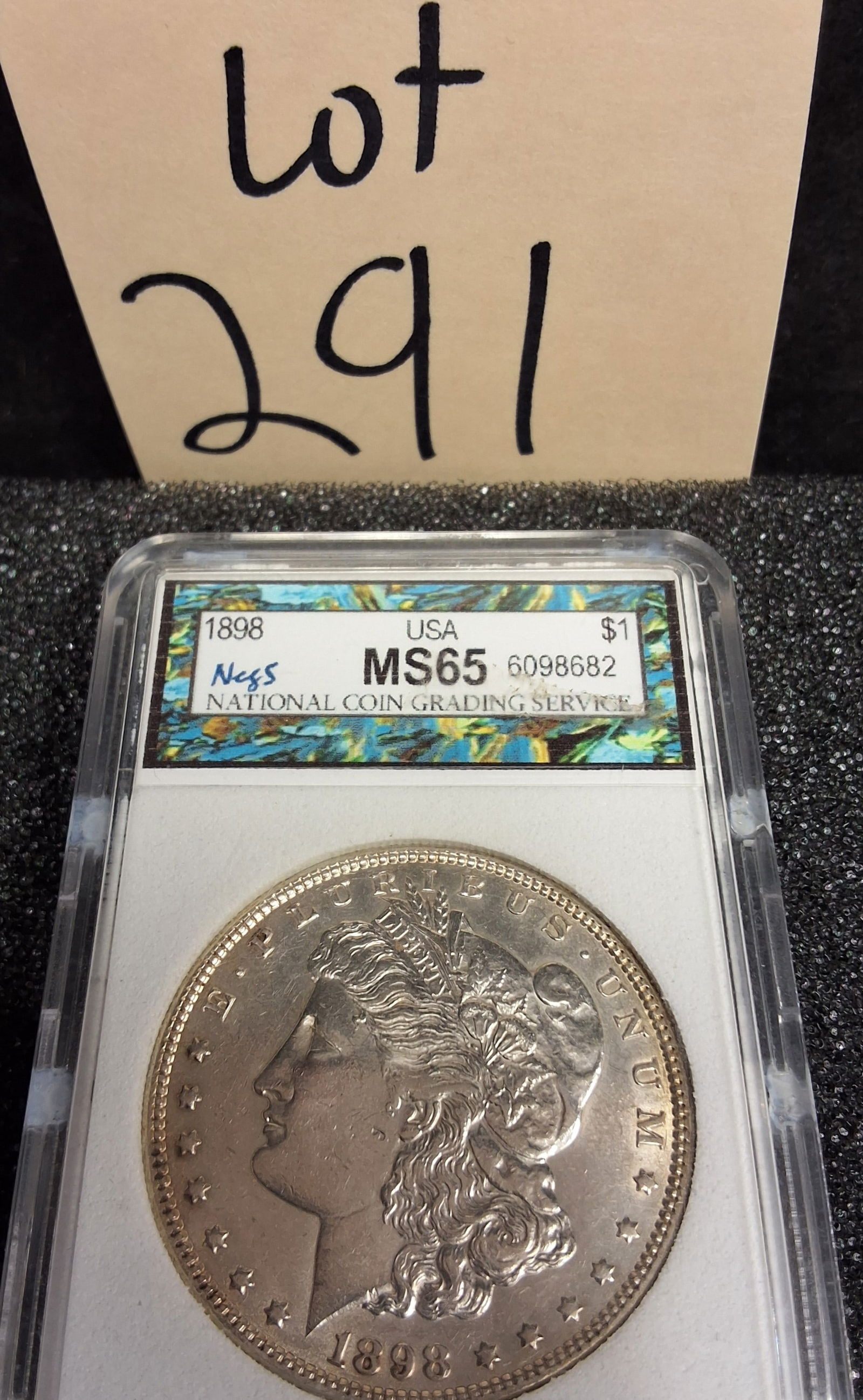 US 1898 Morgan Dollar, Silver, MS65: Catalog number KM-110. Designer George T. Morgan. Philadelphia Mint. Morgan obverse / Eagle reverse. The 1898 Philadelphia issue had a total mintage of 5,884,000.ConditionAll property is sold in "as