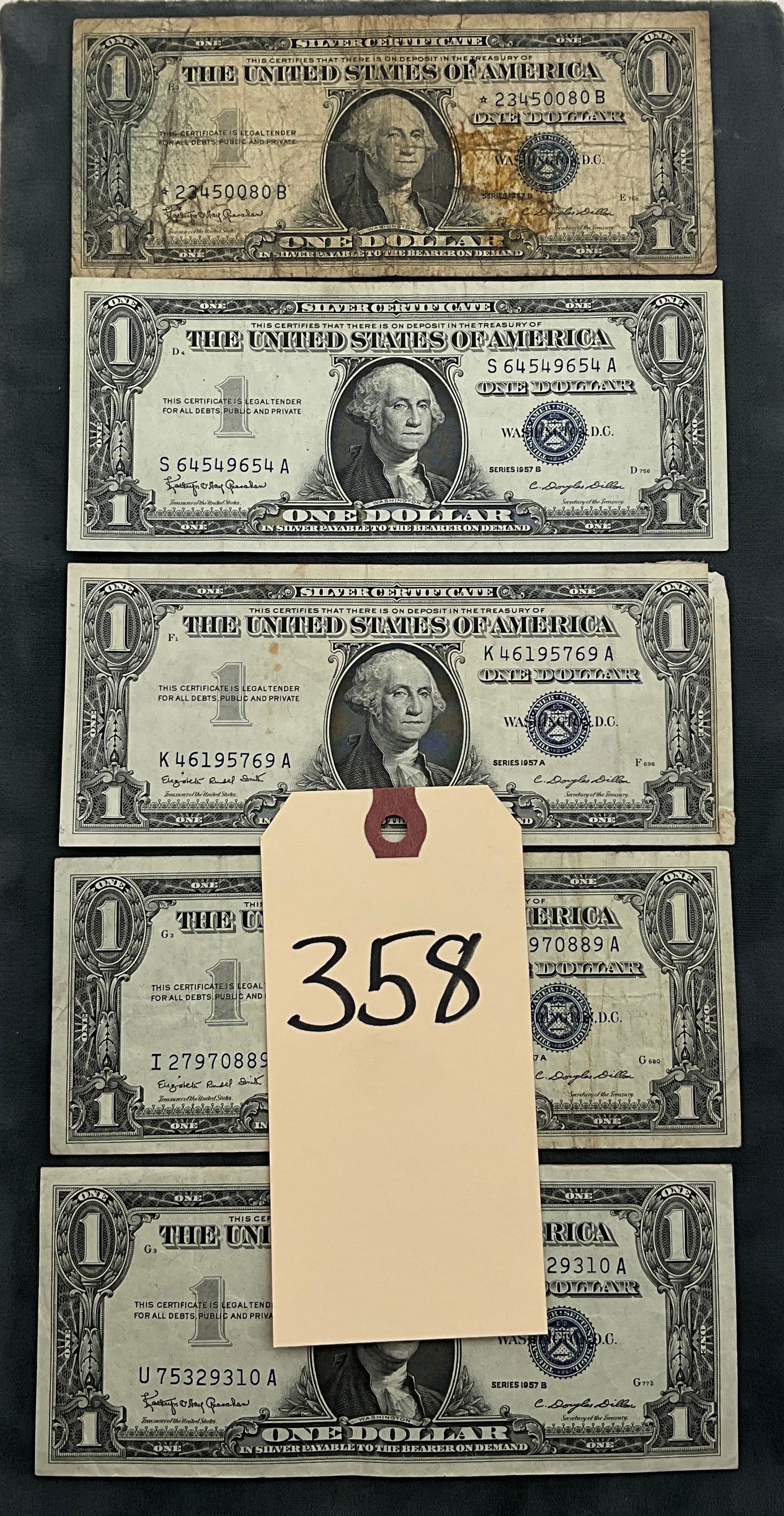 US 1957 $1 Silver Certificates, Paper, Fr. 1620/1621, A Group of Banknotes: This collection consists of US One Dollar Silver Certificates from Series 1957 A and 1957 B, corresponding to Friedberg numbers 1620 and 1621. The lot includes one replacement star note, star serial 2