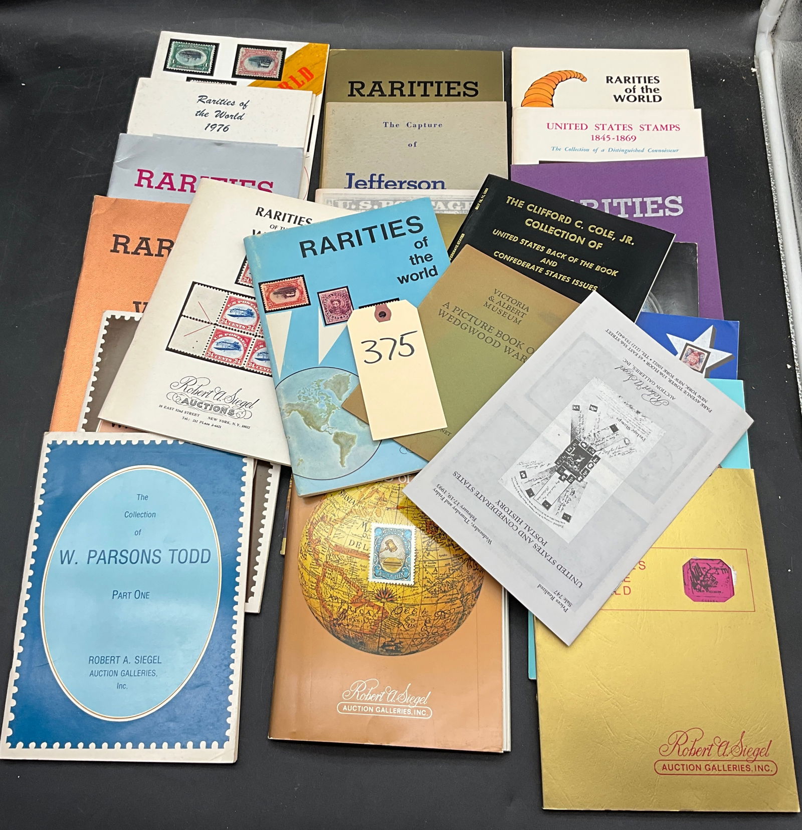 US 1976-1993 Robert A. Siegel Philatelic Auction Catalogs, Group of 15+: This group contains approximately 15 reference catalogs from Robert A. Siegel Auction Galleries, including Rarities of the World editions and the W. Parsons Todd Collection. Key items depicted