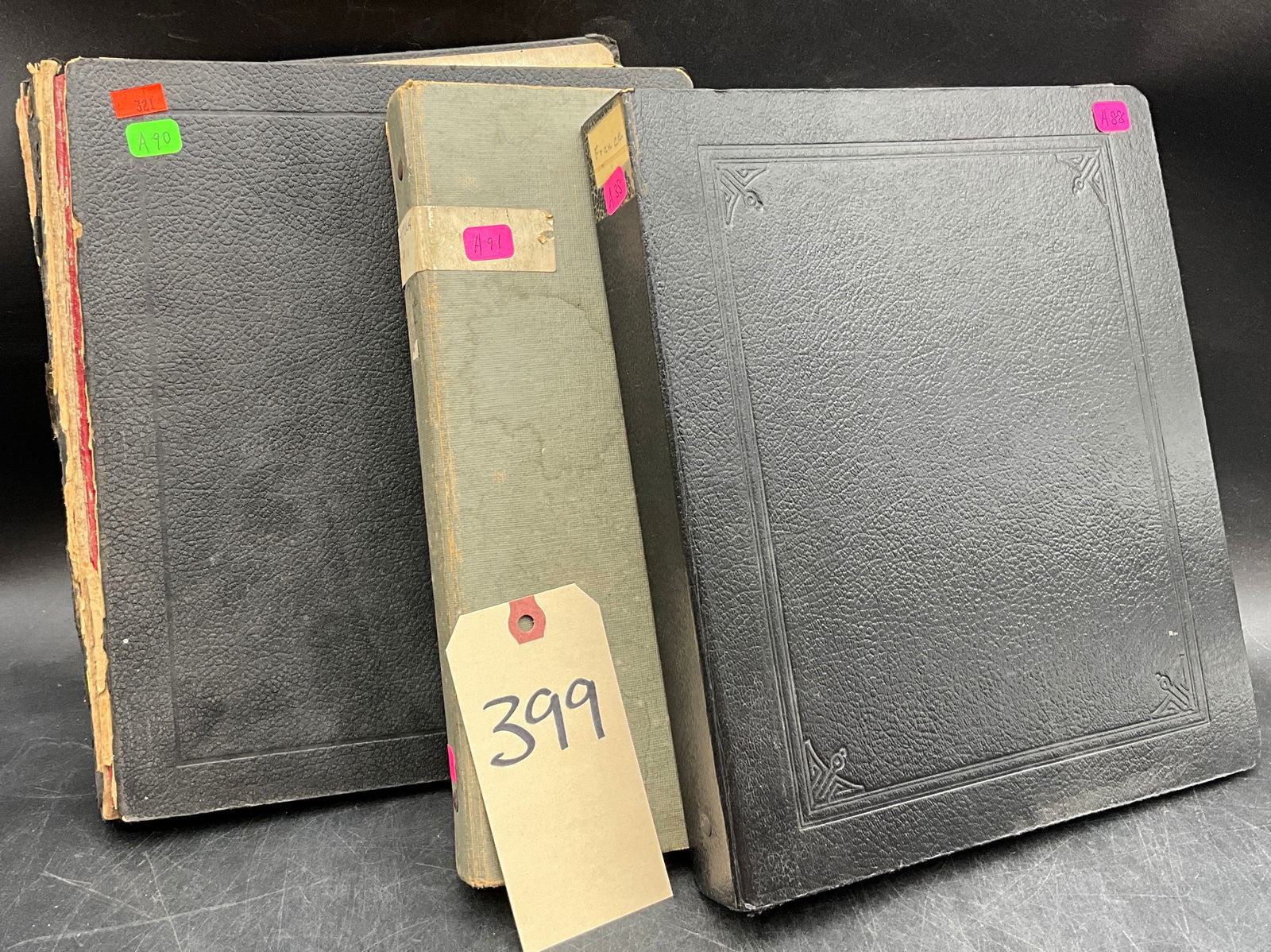 A Collection of Philatelic Stock Binders Containing International Postage Stamps.: This collection comprises three three-ring philatelic binders, including two in black textured hardcover and one in green cloth. The volumes contain numerous stock pages housing a diverse assortment o