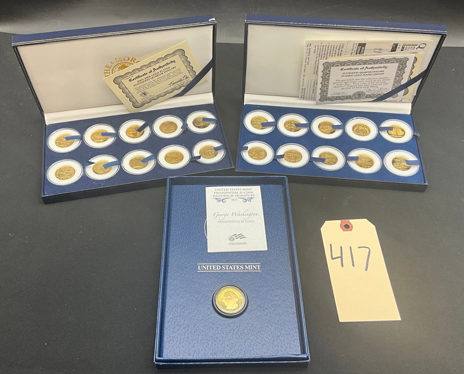 US 1999-2006 Statehood Quarters and Washington $1 Coin, Gold-Plated: This trio includes two Morgan Mint sets of twenty 24-karat gold-plated Statehood Quarters (1999-2000 and 2005-2006) and one US Mint George Washington Presidential $1 Coin Historical Signature Set.