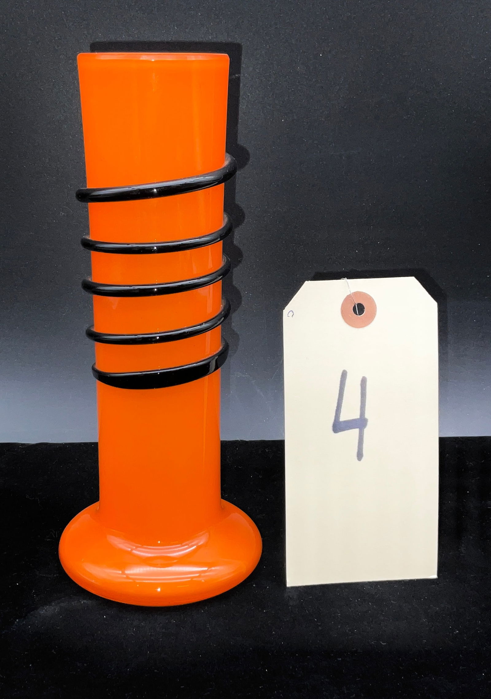 Czech Art Deco Tango Glass Vase: This hand-blown art glass vase is a classic example of Czech Tango glass, likely produced by Loetz or Welz. It features a vibrant opaque orange body accented by a thick, applied black glass spiral tra
