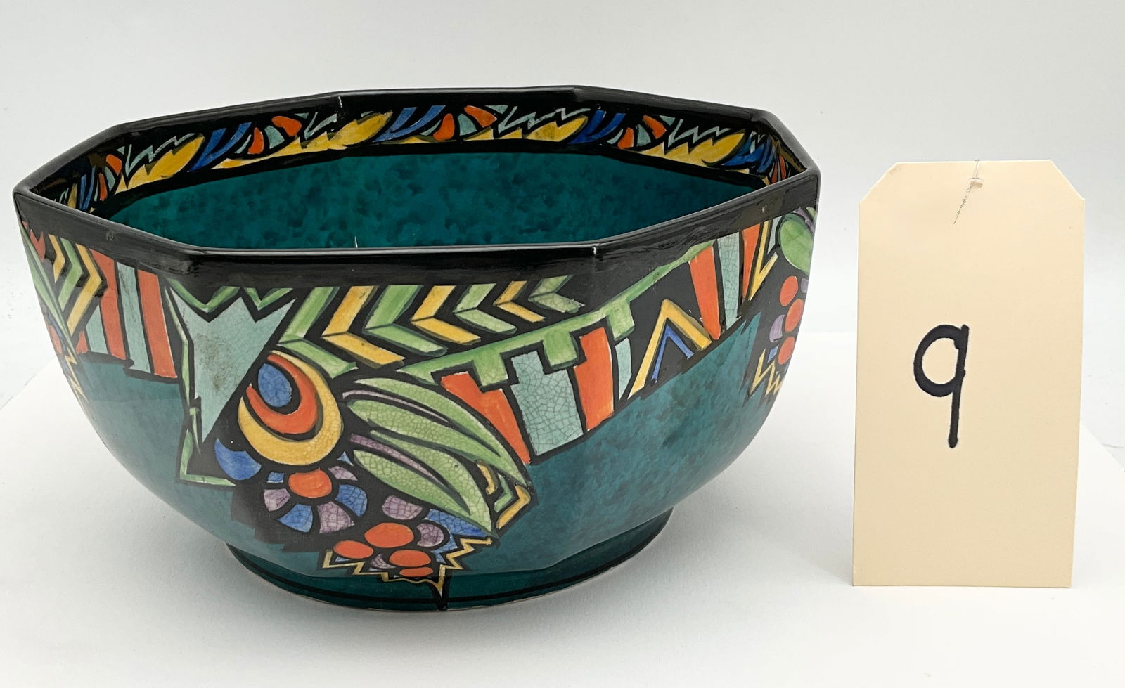 Thomas Forester & Sons Ltd, Hand-Painted Earthenware, Phoenix Ware Octagonal Bowl: This vibrant Art Deco octagonal bowl by Thomas Forester & Sons Ltd features the Ceylon pattern on a mottled teal ground. The exterior is decorated with bold, stylized geometric and floral motifs in a